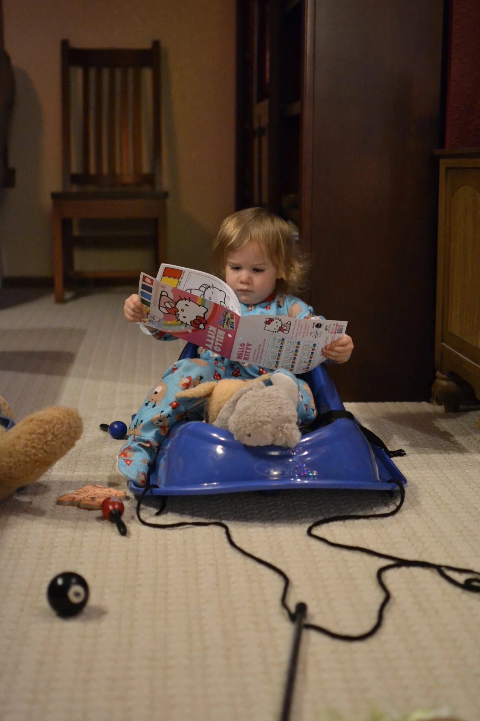 doing some light reading, with her friends, in her new sled