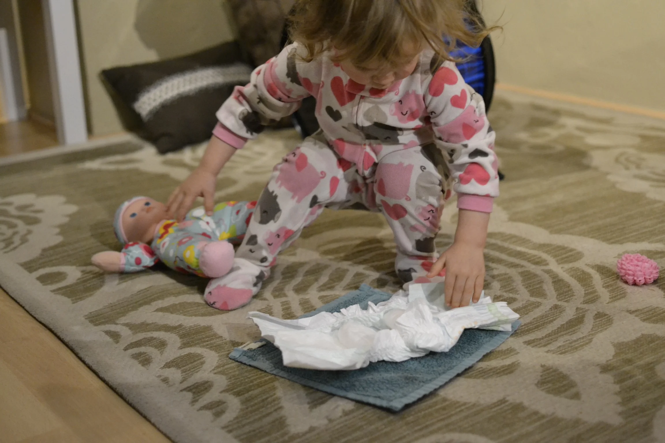 channing decided her baby doll needed a diaper change. she spent a good hour working on that this morning. 