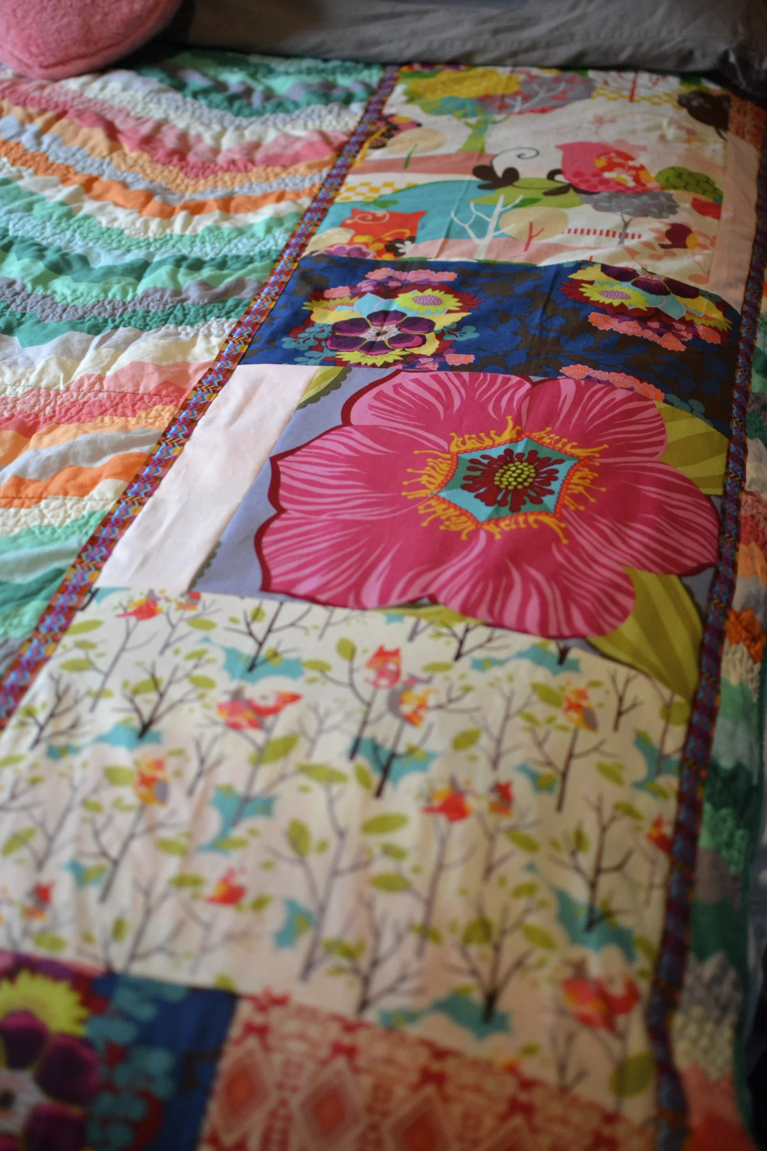 i basically made a long, skinny quilt of the fabrics i liked and then stitched them to the existing quilt. i added an anna maria horner ribbon along each side to finish of the edges. 