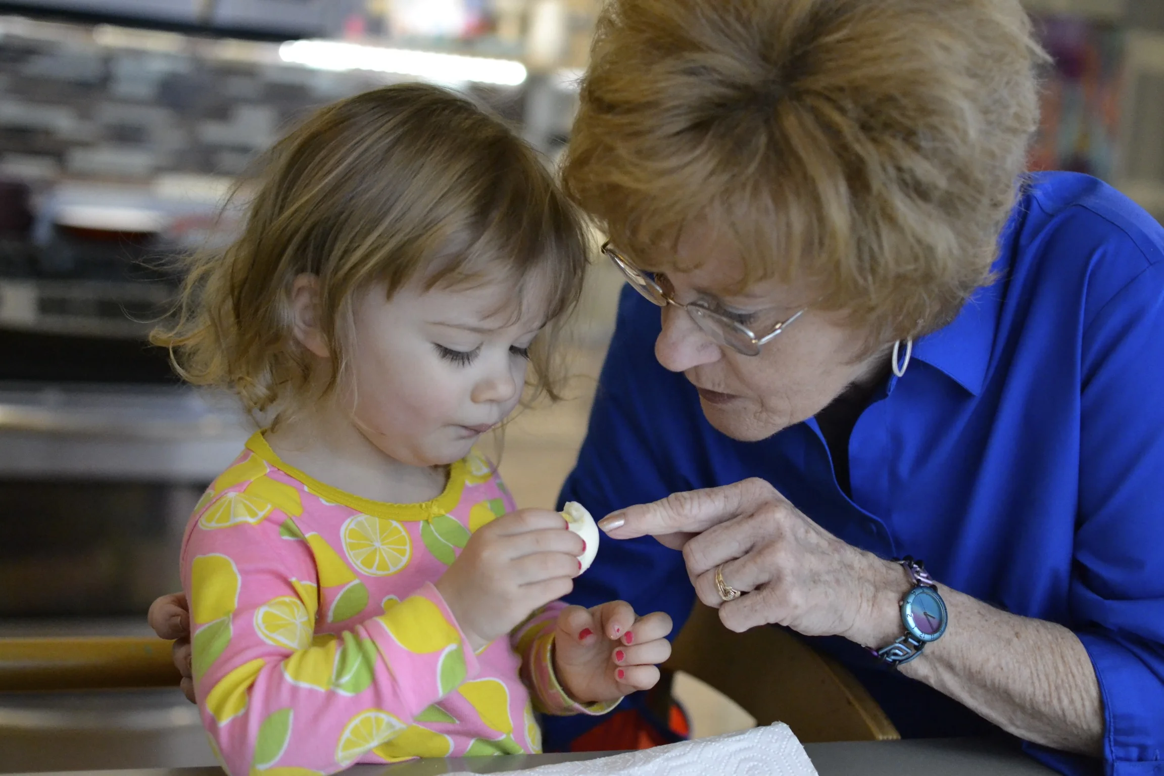 nanna showing channing how to eat her first hard boiled easter egg