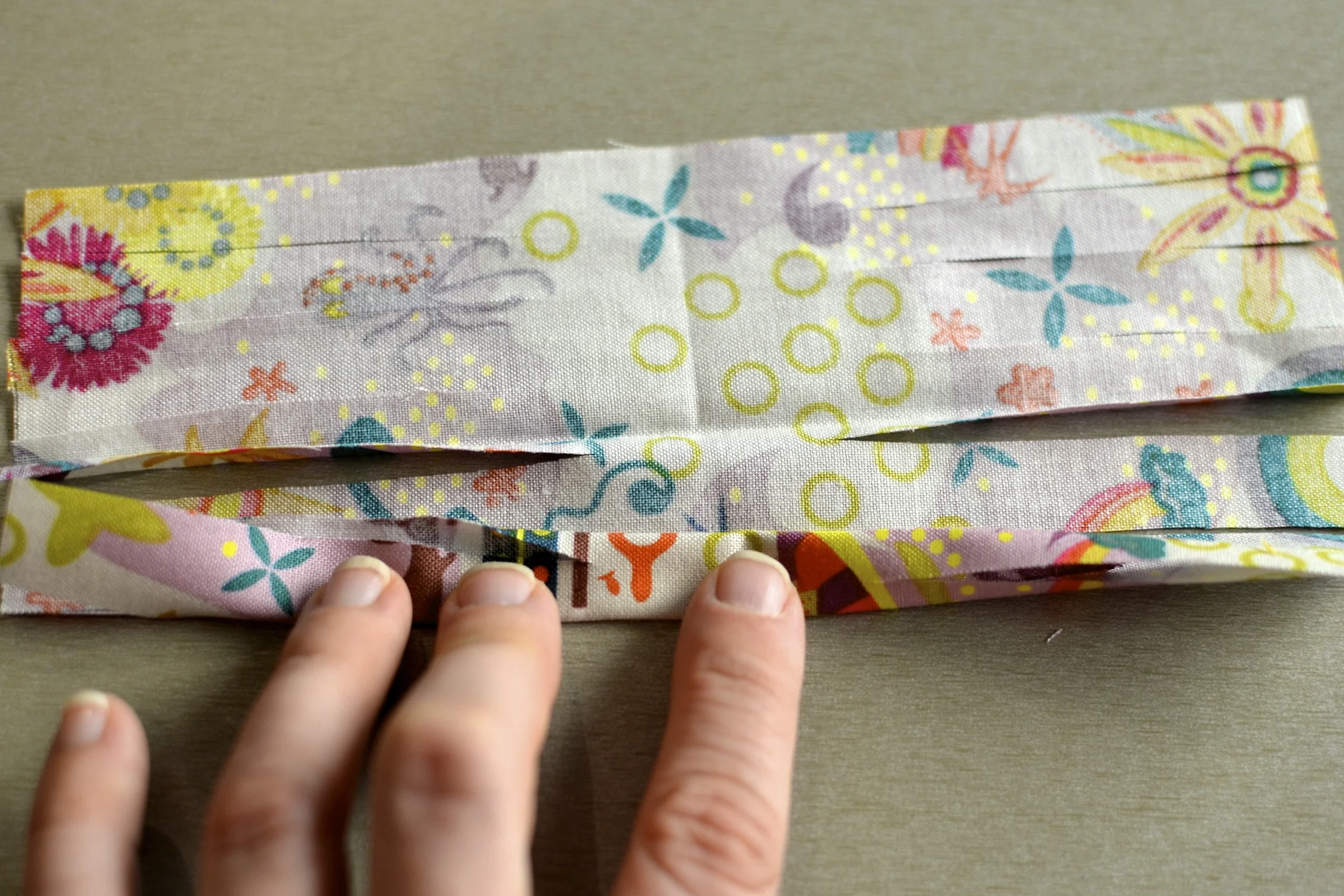 unfold the fabric square and roll/fold it up all the way.