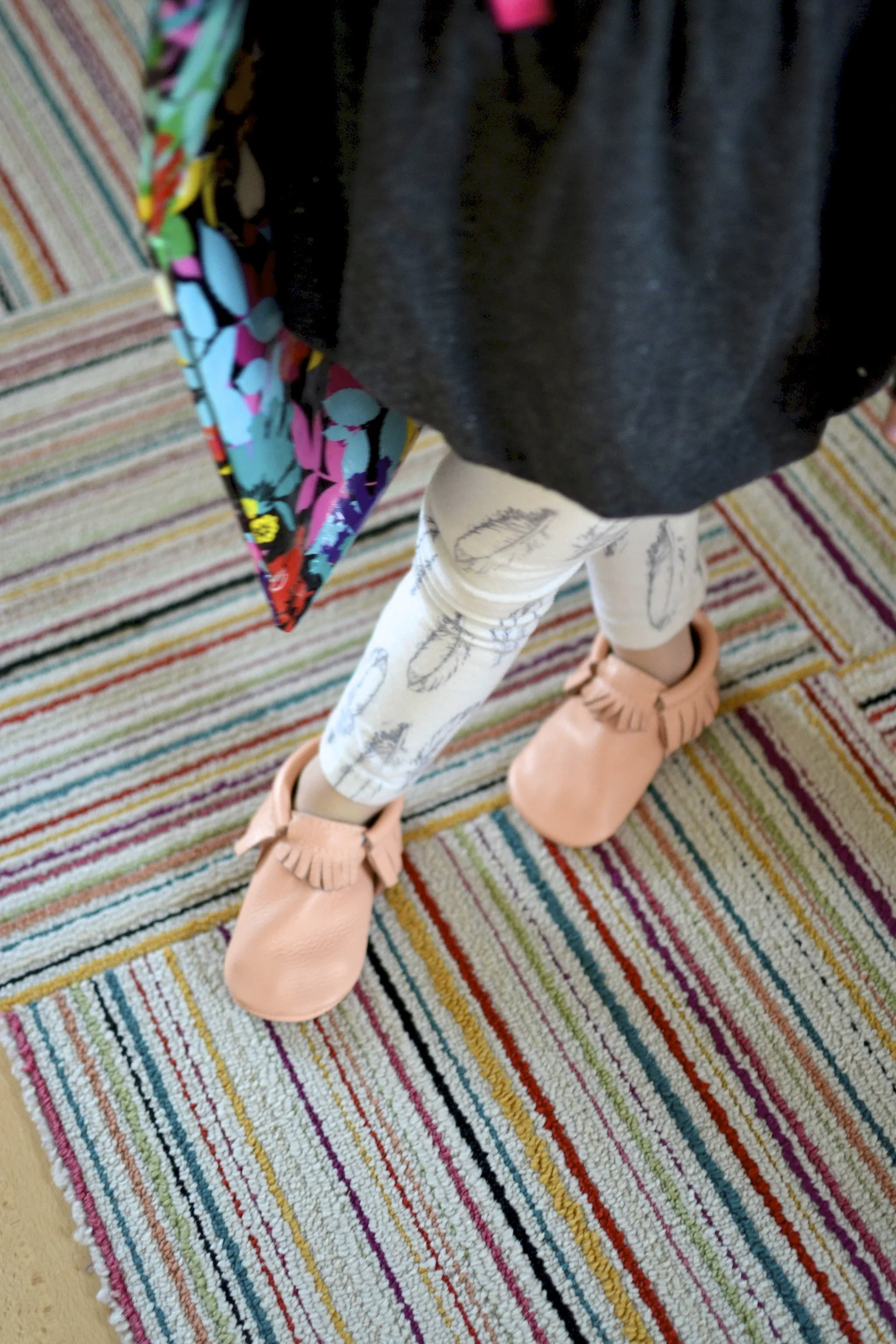 on our way to the library. moccs on our feet and library bag over her shoulder. 