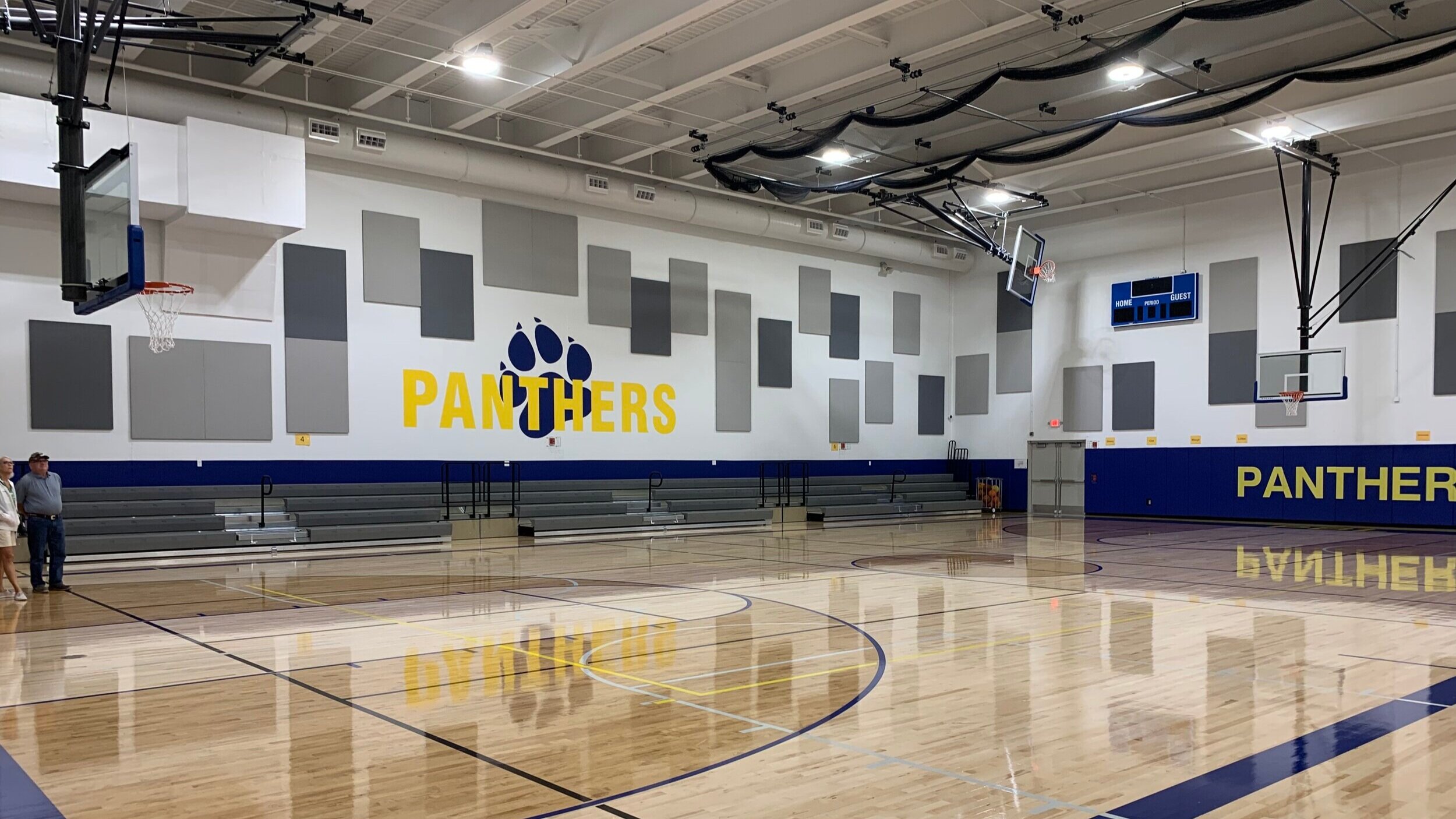 New Gym The new gym provides an additional competition-sized athletic facility for the district and community’s needs. A mix of minimalist whites and grays help balance the school’s traditionally bold blue and yellow, creating a refined and modern p…