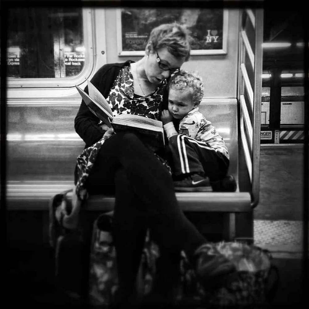 Jabali Sawicki/ @jsawicki1/Instagram : Original caption via Instagram: #pscommute 5:15 PM on the C Train. 34th Street, Penn Station back home to Fort Greene, Brooklyn. Giving the gift of reading. A magical moment between mother and son. It may seem like just another subway ride, but with a book and an imagination, the adventures are limitless.