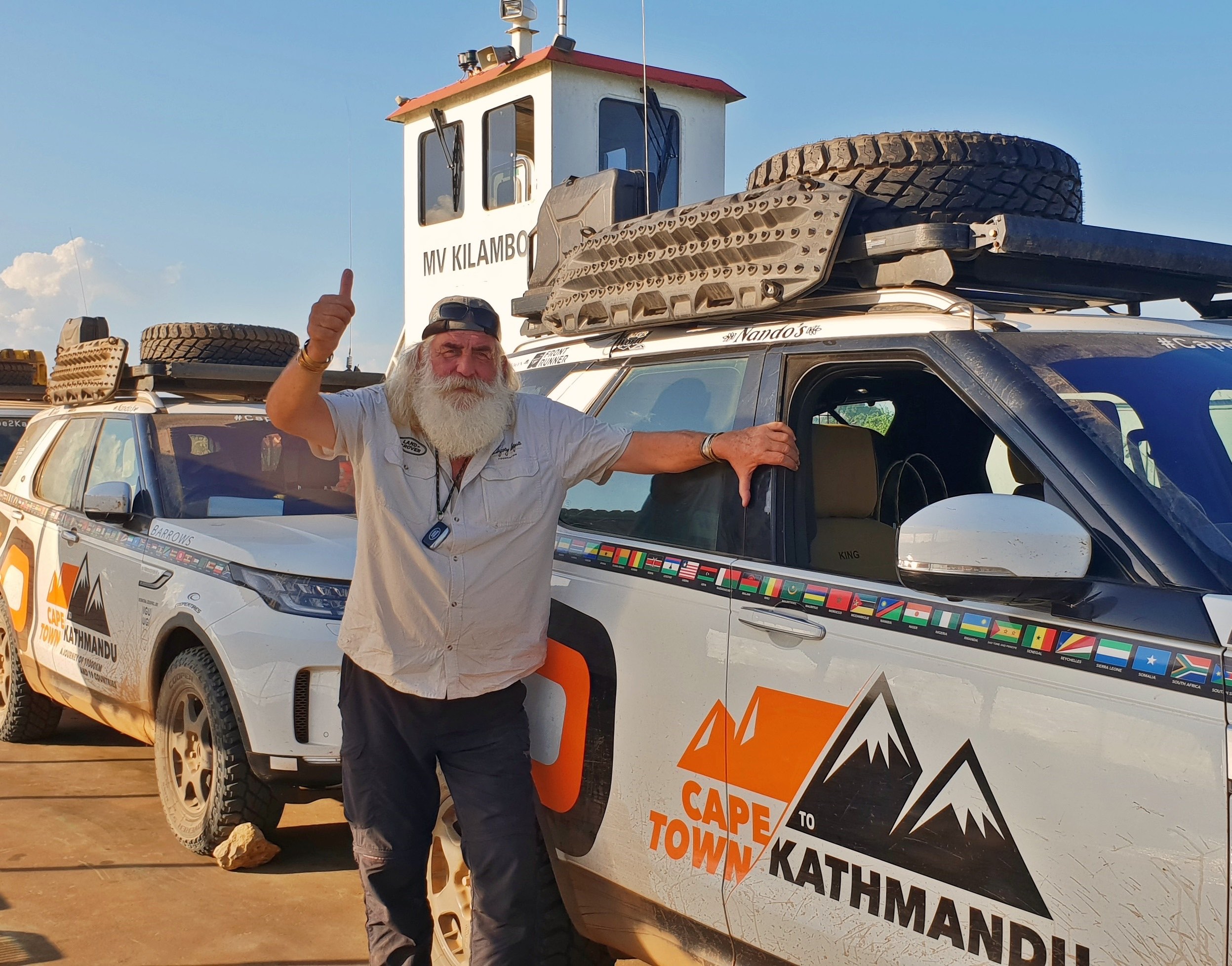 Kingsley Holgate with Landies on the ferry across Rio Rovuma..jpg