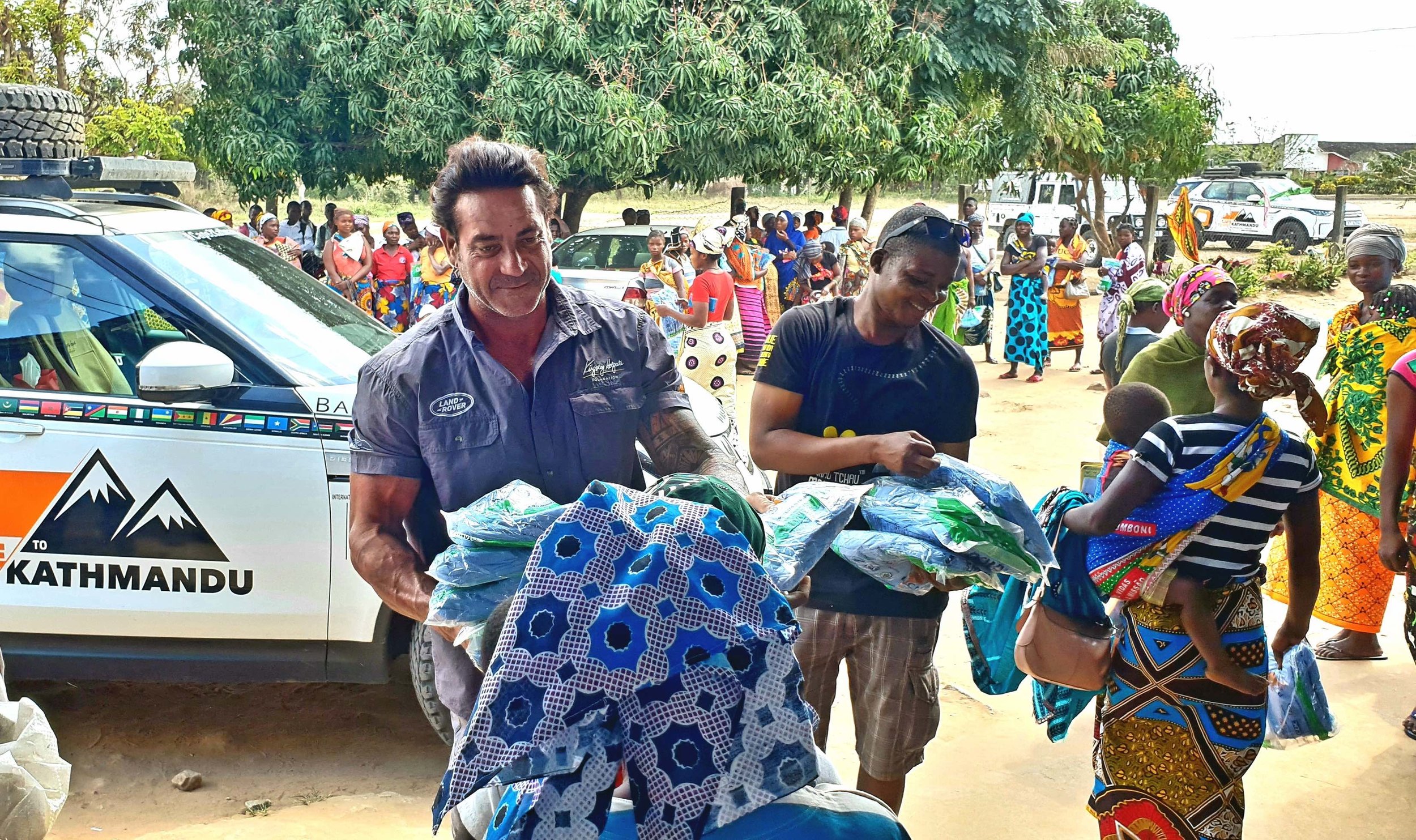 Ross Holgate and Babu Cossa (Mozambiquan malaria education team member) distribute bed-nets to mothers and pregnant women at high risk of malaria at the Carapira maternity clinic, Mozambique 20180820_170951.jpg