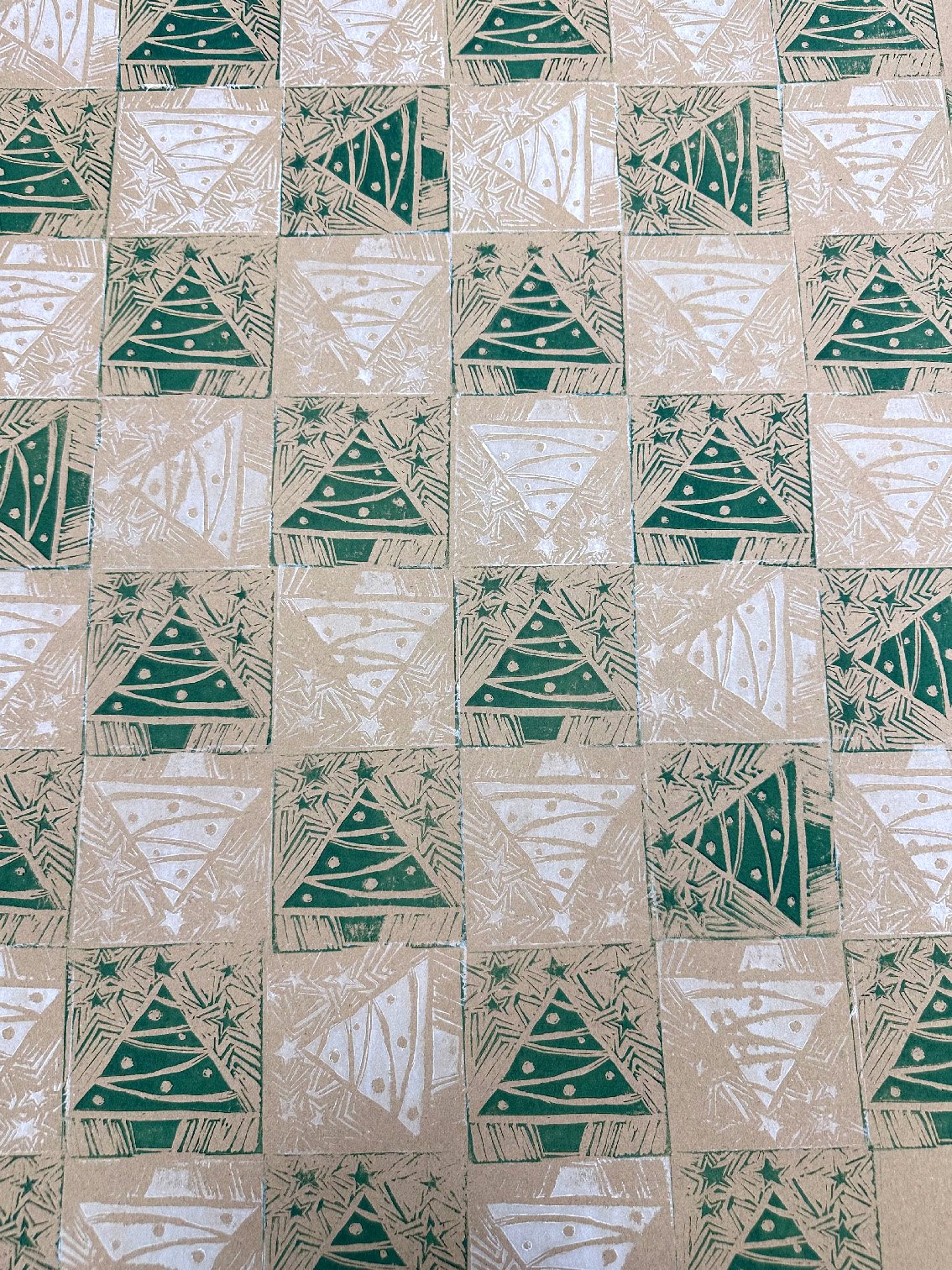 Block printed Christmas trees hand printed onto brown gift wrap paper