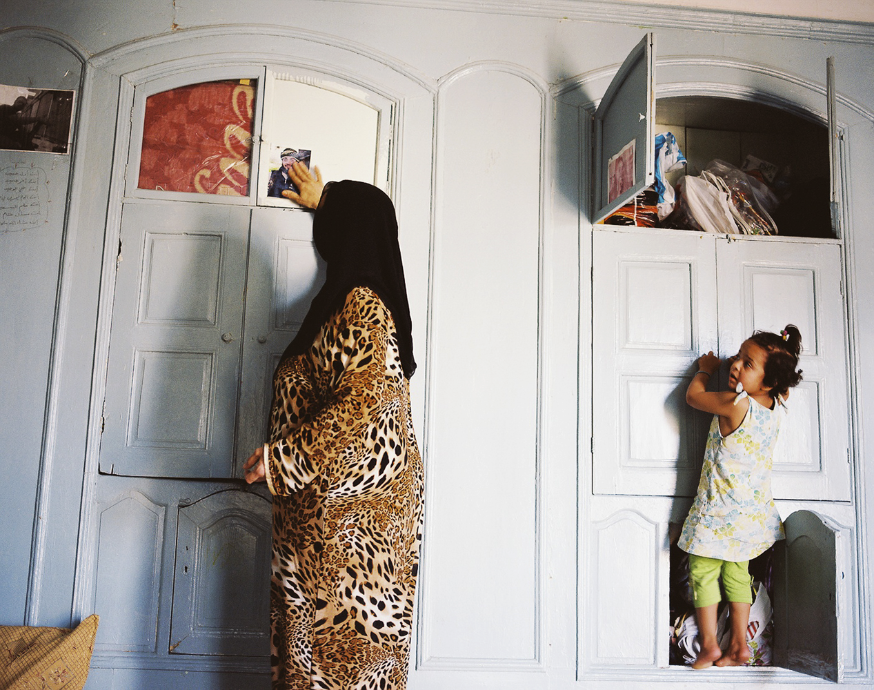 Omsami (meaning "mother of Sami") 55-years-old from the countryside of Aleppo currently lives with her daughter-in-law and four grandchildren at a shelter for Syrian widows in Gaziantep, Turkey. Here, she caresses a photograph of her son Sami who was killed by the Assad regime while fighting for the FSA (Free Syrian Army) nearly two years ago. 