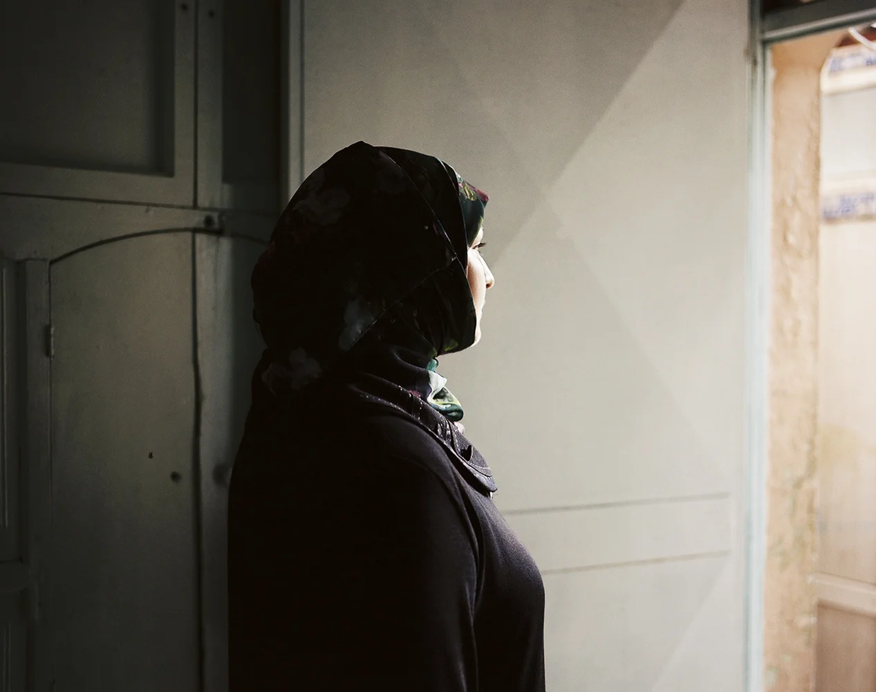 Fathya (25), suffers verbal and physical abuse from her younger 17-year-old brother, who has been designated by her family to keep an eye on her. When this image was made, she was waiting to hear if her family would accept a marriage proposal from a 60-year-old Turkish man to take Fathya on as a second wife. She does not want to marry again, but her family insists that she does and forbids her to study. "Maybe if I was educated, my whole life would be different." Fathya would go through a bad marriage again to escape her overprotective family. (Last I heard, a woman running this women's center had convinced Fathya's family to decline the Turkish man's proposal.)