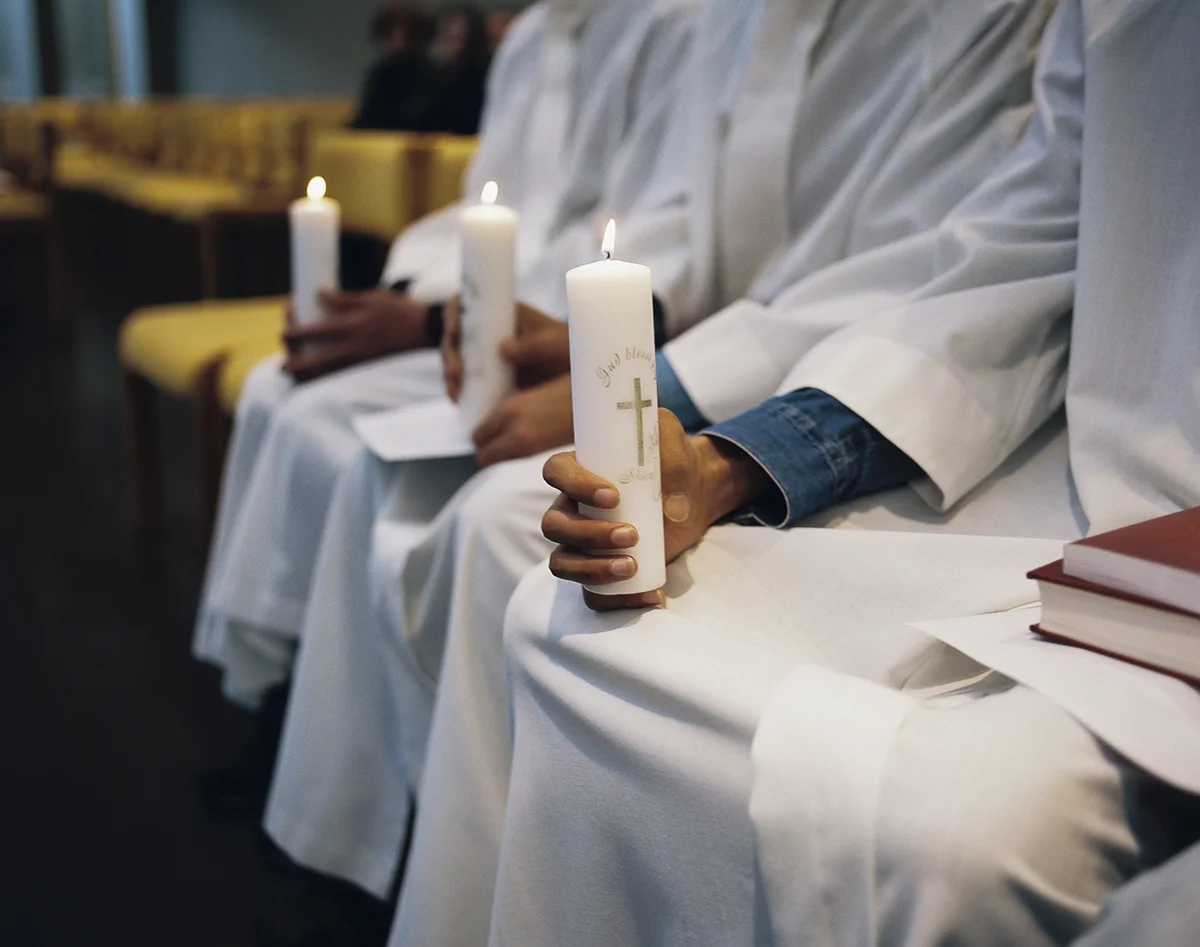 Three asylum seekers recently granted asylum from Iran at the baptismal font during a Sunday service at Hjallakirkja church. The men adopted new Christian names: Daniel, Benjamin, and Abraham.