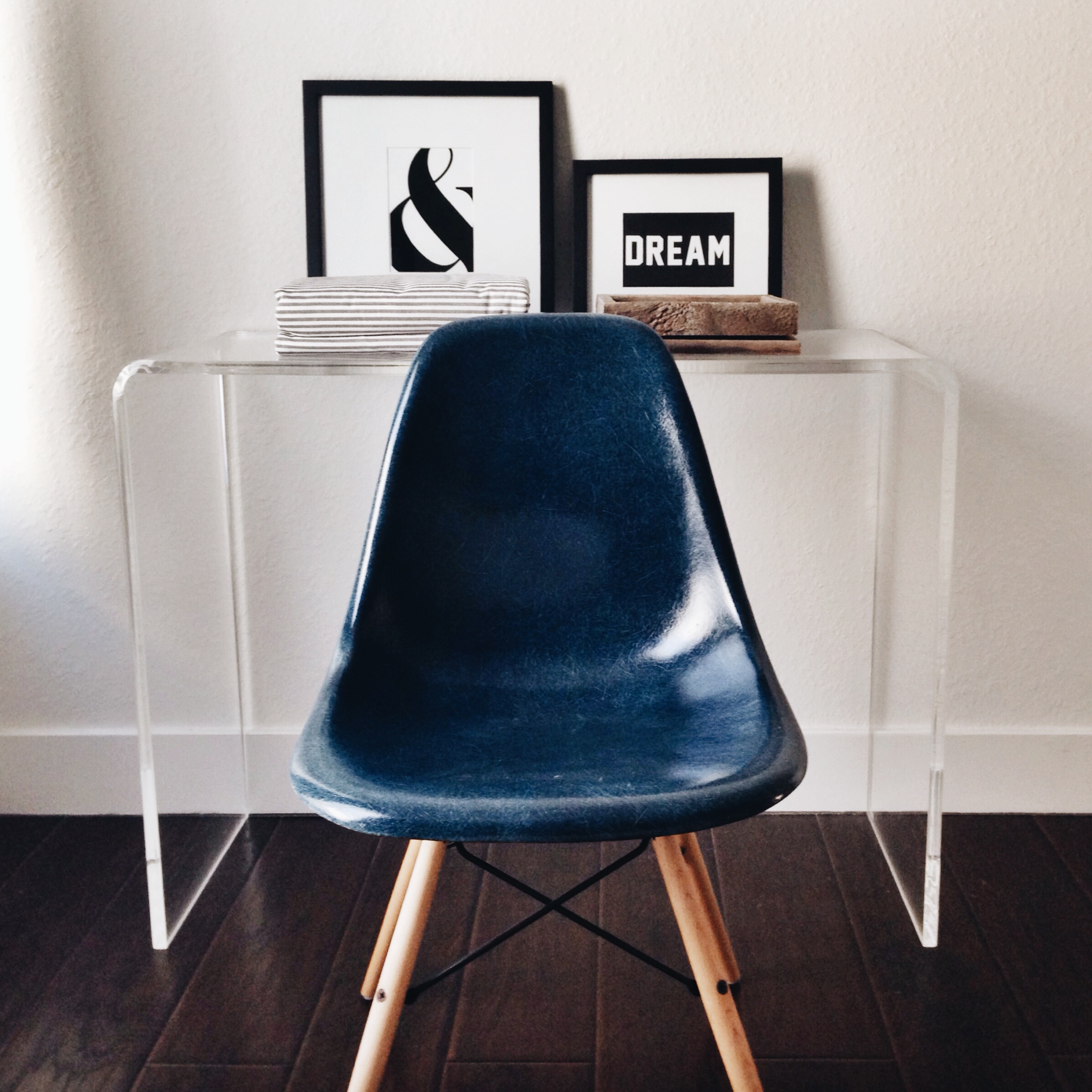 WEST ELM gallery frames / HERMAN MILLER antique Eames chair (via Etsy ) / CB2 clear console table / RUSTICDECORFRAMES picture frames (via Etsy)