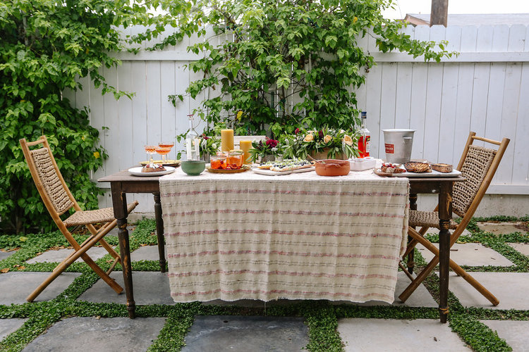 I don't always use actual tablecloths. Sometimes, I'll buy a piece of fabric that I love and throw it on a tabletop. It doesn't have to fit or even cover the entire table. Amazing florals, per usual from Pick Tulip