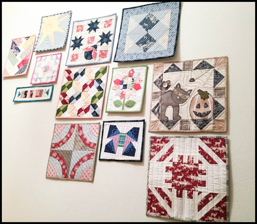 Birthe of Norway sent me this photo of her mini quilt wall that goes up the stairs!
