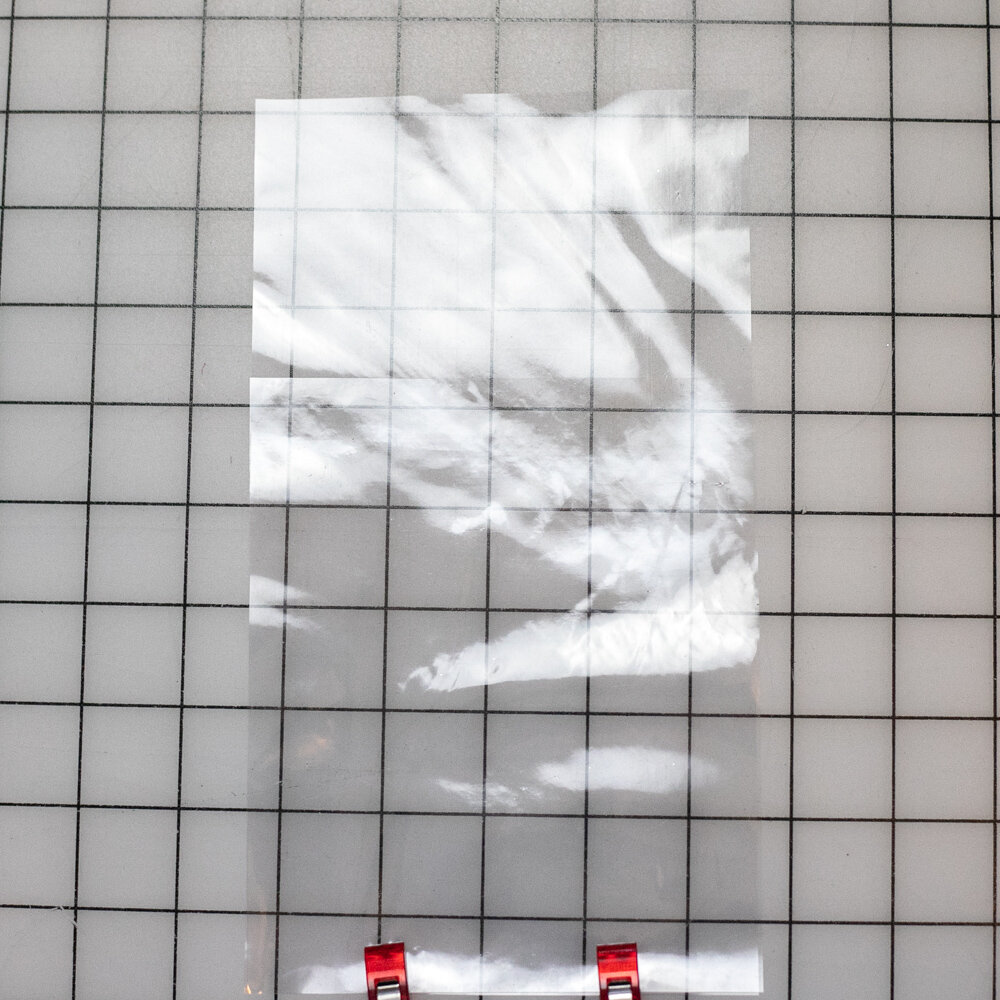 Two vinyl pieces clipped together at the bottom, with the smaller piece on top.