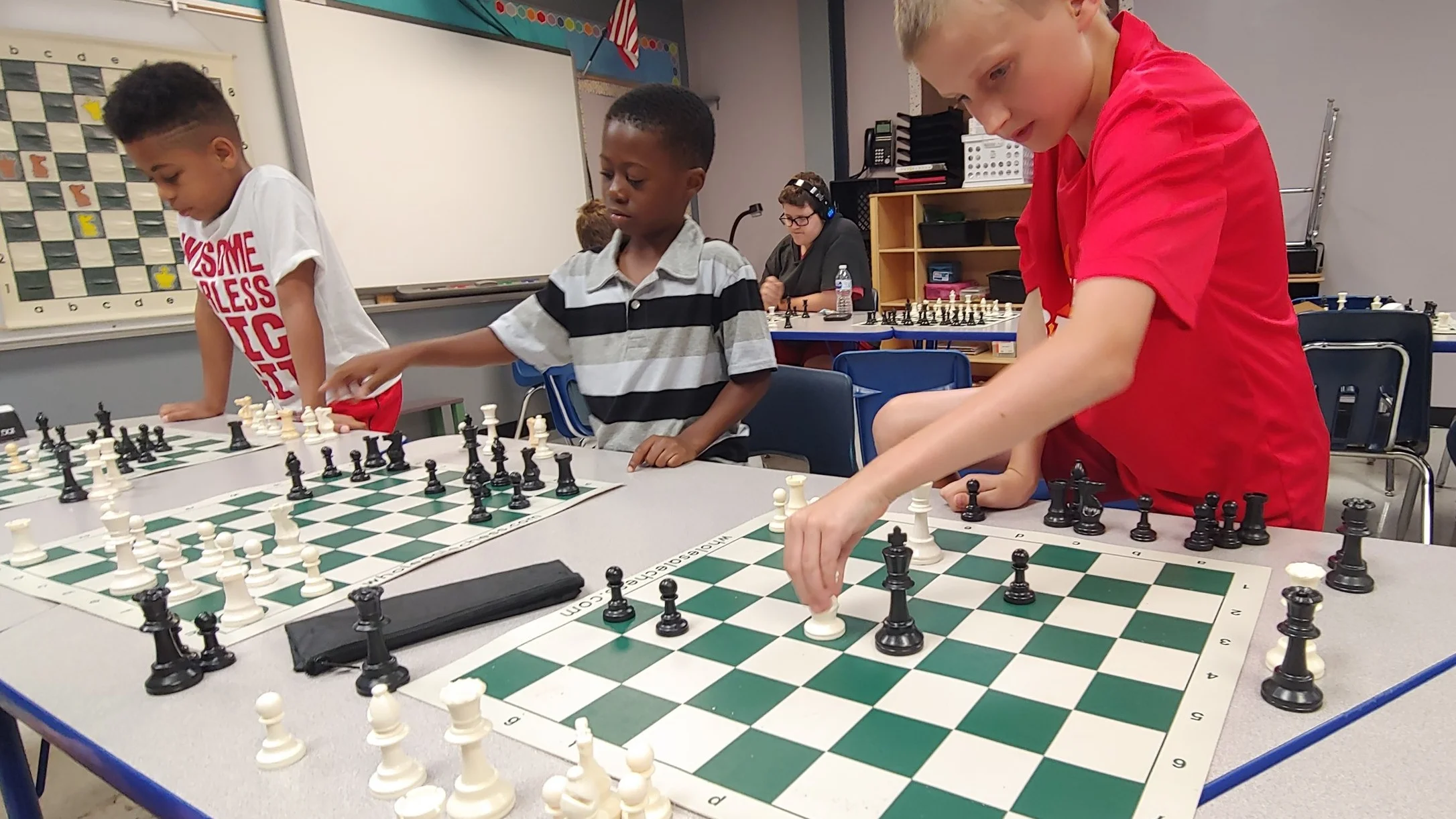 7-year-old Izaiah, center, practices his favorite moves at LINC’s summer chess camp July 17 at Genesis School.