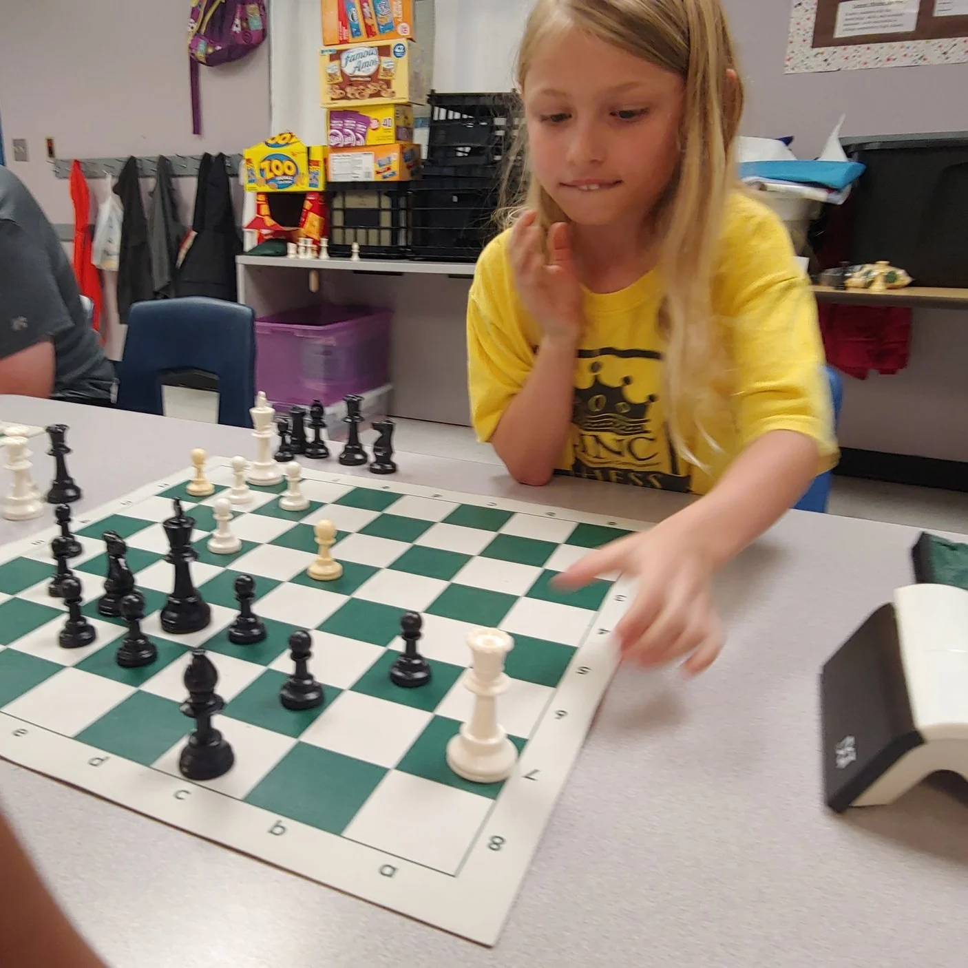 Kendall, 7, makes her next move at LINC’s chess camp July 17.