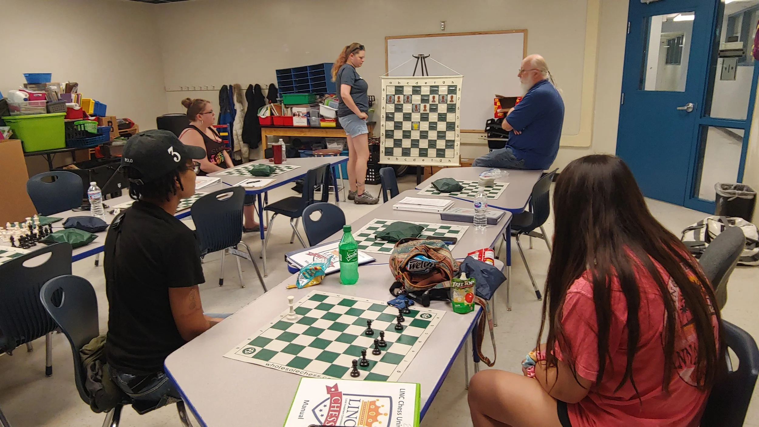 LINC staff and parents at LINC’s Chess University learn strategies to teach the game to students July 17 at Genesis School.