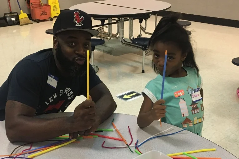Smith Liddell and his daughter, Sasha Liddell, show off her craft idea at the first Fort Osage FAST family gathering Sept. 3.