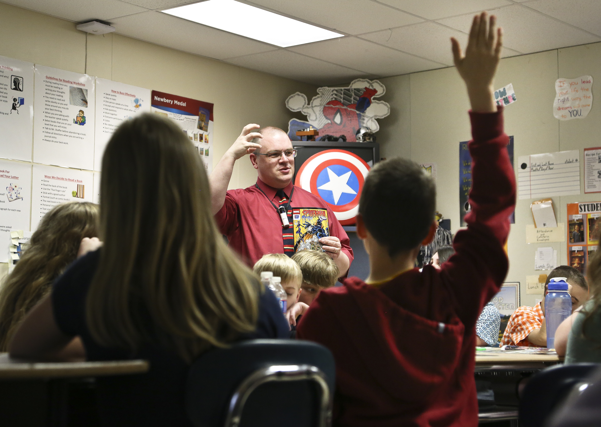 Fifth-grader Tyler Rake, 11 raise his hand while Scott Shaffer, communication arts teacher reviews the story of Spider Man, Storm and Cage with the battle of Smokescreen at South Eastern Middle School West, Fawn Township Monday, April, 28, 2014. Students weigh in their thoughts about smoking and the roles of the super heros in the comic book. Photo by Sonya Paclob