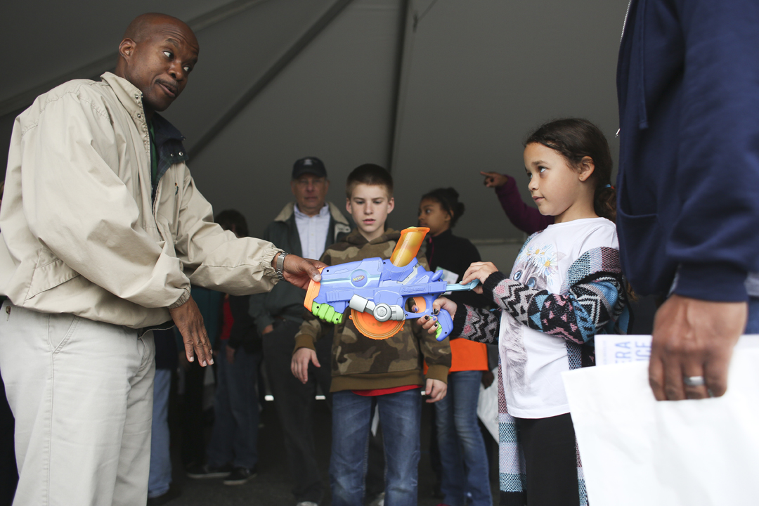 From Left, Staff Dr. Paul Gaye holds a Nerf Gun to demonstrate proton therapy to seven-years-old Olivia Waltz and William Waltz of Hampton at the Jefferson Lab Open House in Newport News, Saturday, April 30, 2016. (Sonya Paclob / Special to the Daily Press) 
