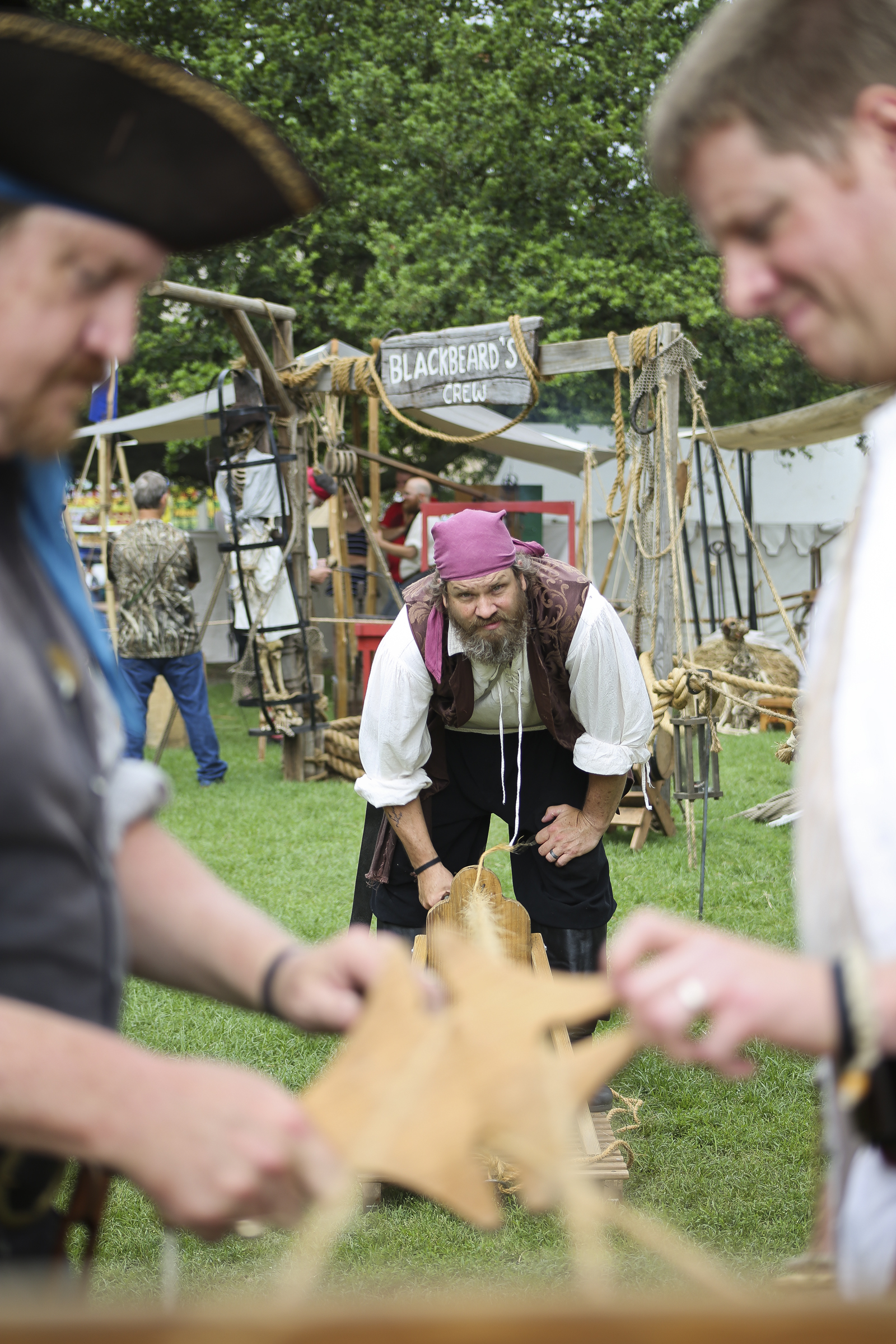 From left, Living historians Barnabee Wylde of Virginia Beach, Paul Schubert of Virginia Beach and Rusty O'Toole of Gatesville in North Carolina, work together to making rope at the the Blackbeard Pirate Festival, Hampton, Saturday, June 4, 2016. (Sonya Paclob / Special to the Daily Press)