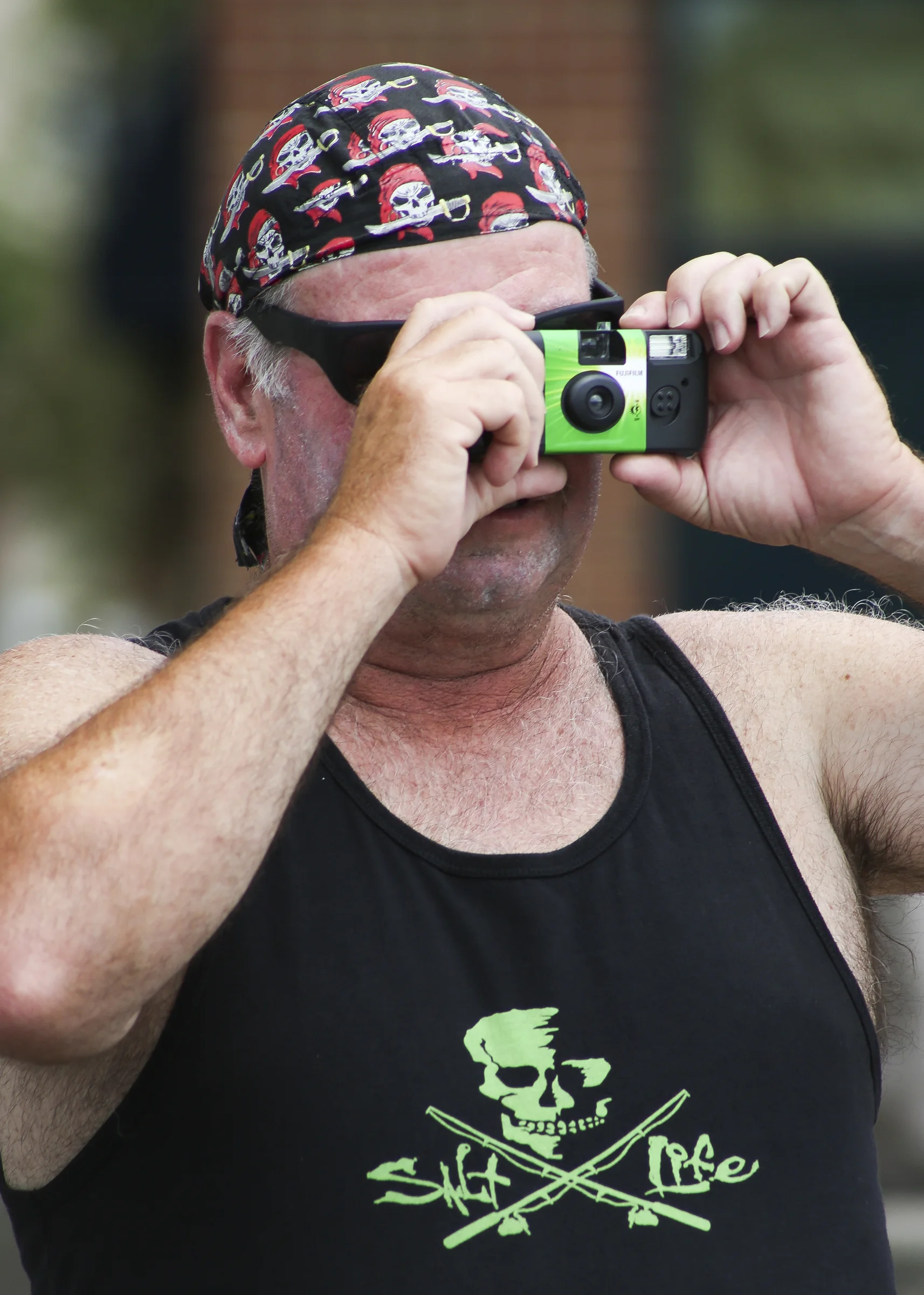Lenny Temple of Moyock, North Carolina takes a picture with his disposable camera during the Blackbeard Pirate Festival, Hampton, Saturday, June 4, 2016. (Sonya Paclob / Special to the Daily Press) 