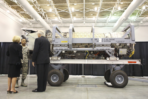 From left, Senior Airman Michael Martin describes the F-22 Engine to Air Combat Command Chief Scientist Dr. Janet Fender and Dr. John Otten of Williamsburg at Langley Air Force Base 100th Anniversary Gala, Hampton, Saturday, Sept. 17, 2016.