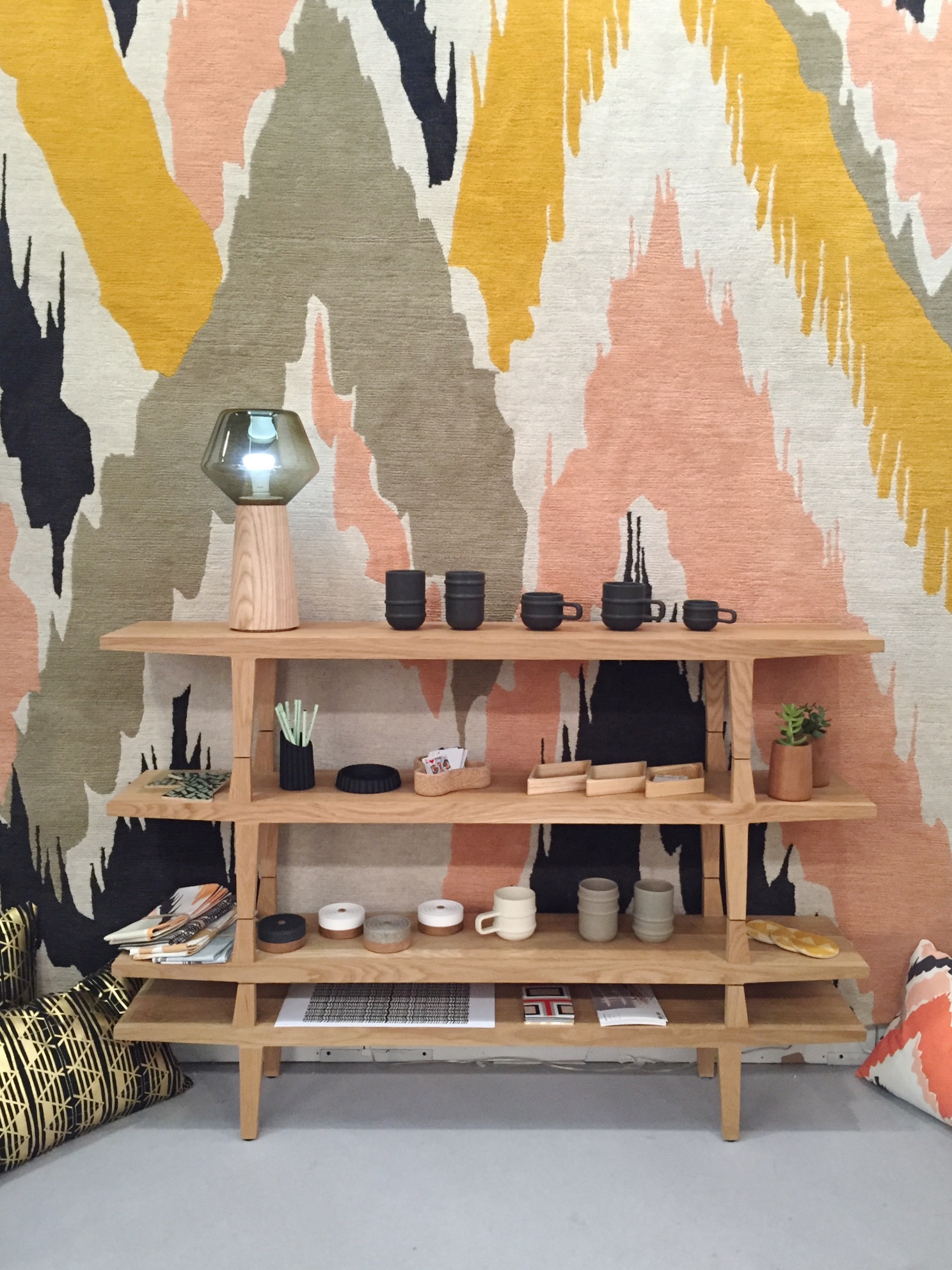 Stackable shelving in a natural finish by 100xbtr and a most beautiful rug by Wolfum.