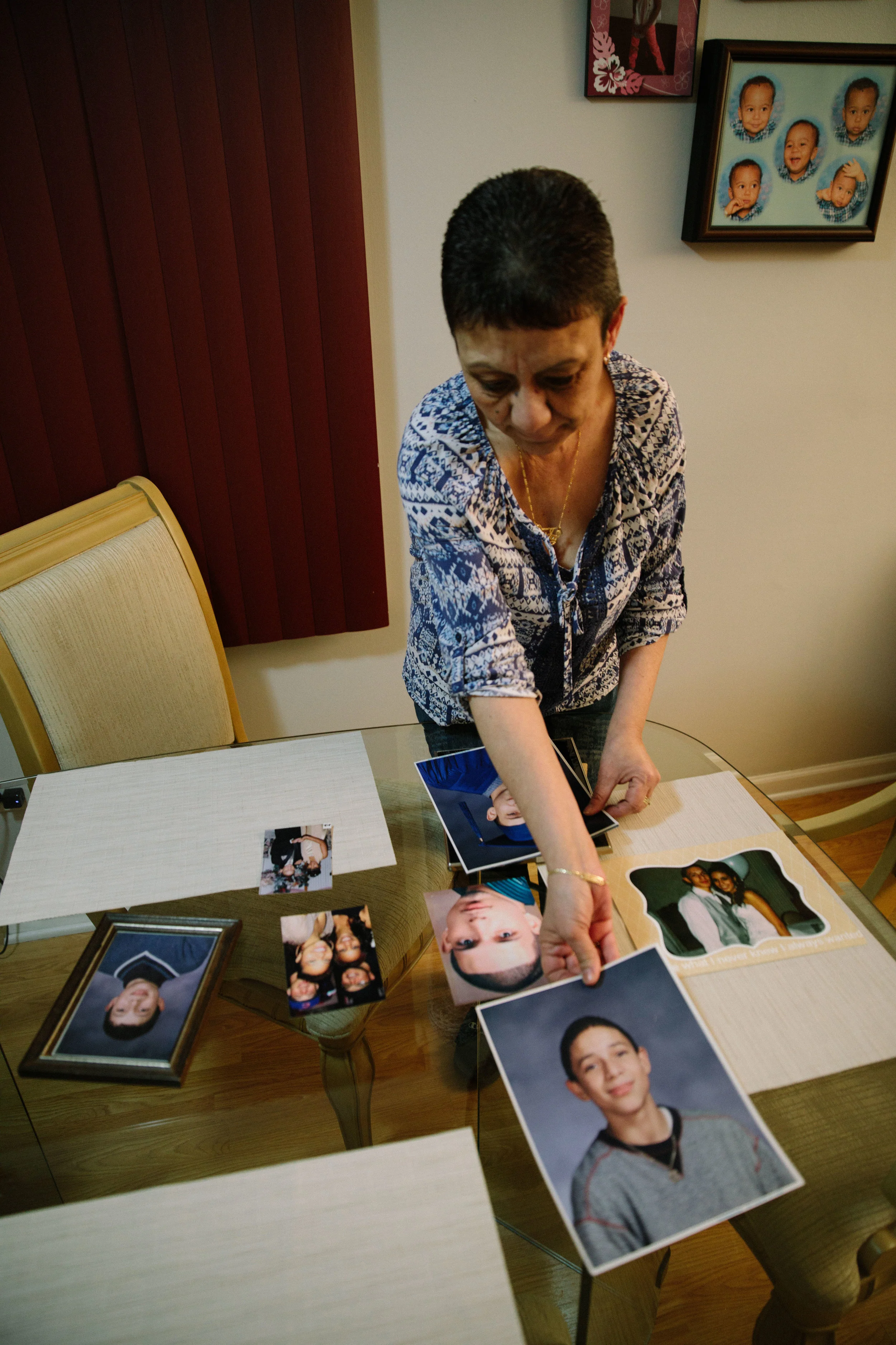 Elizabeth Ramirez lays out photos of her son, Dee Jay Rodriguez, on the dining room table. In October 2011 Dee Jay was shot and killed in his apartment in Chicago's Bellmont-Cragin neighborhood. In the aftermath of her son's murder, Elizabeth helped found Parents for Peace and Justice, a support and advocacy organization that comes alongside families who have also lost children to gun violence in Chicago. MCC partners with Parents for Peace and Justice to help support their important work.