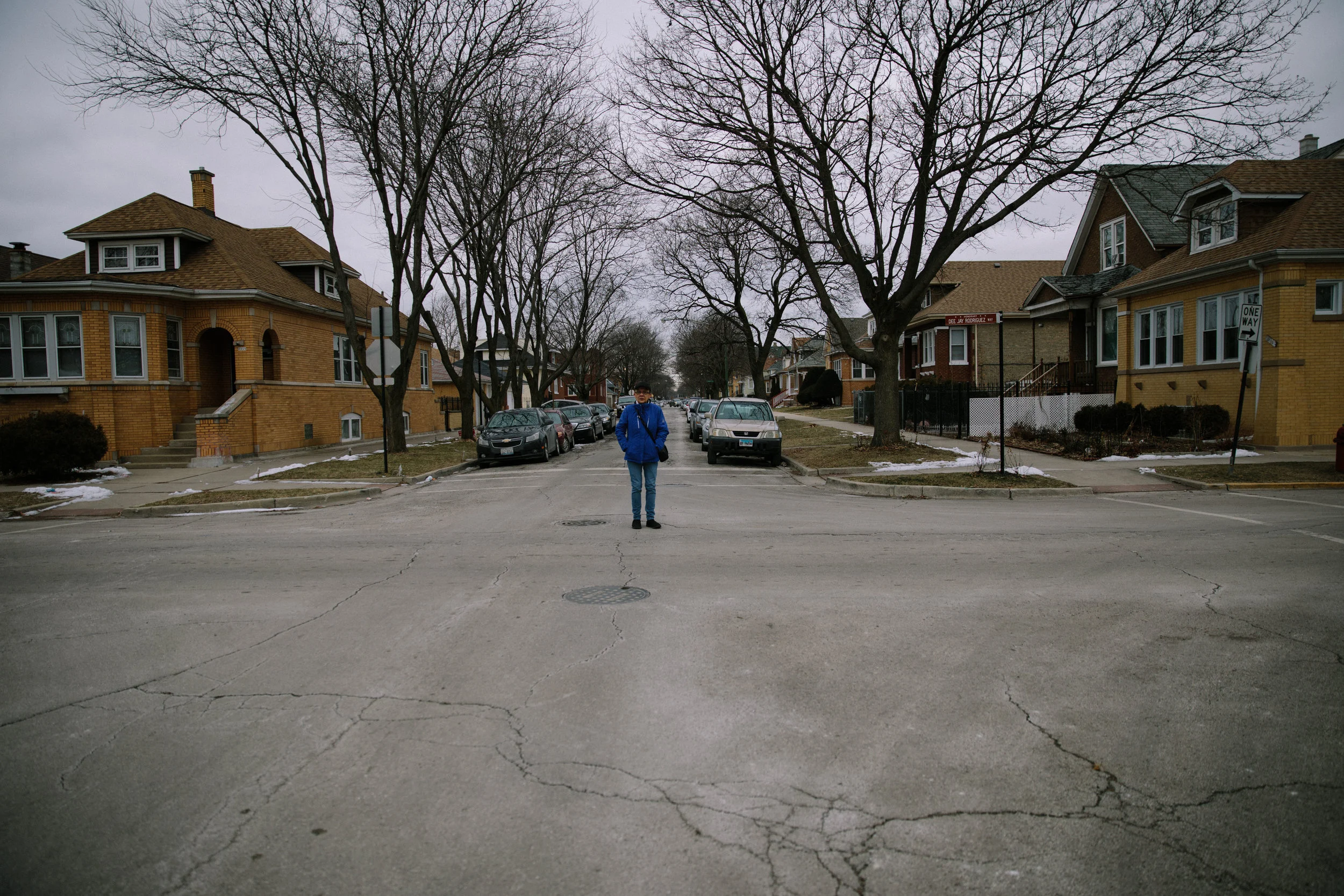 Elizabeth Ramirez stands at the intersection of Belden Ave and Leclaire Ave near Blackhawk Park on Chicago's west side. An honorary street sign stands at the intersection for Dee Jay Rodriguez Way. Dee Jay, Elizabeth's late son, was shot and killed in October 2011. In the aftermath of his death, Elizabeth helped create Parents for Peace and Justice, a support and advocacy organization for families who have lost children to gun violence in Chicago. MCC partners with Parents for Peace and Justice to help support their important work.