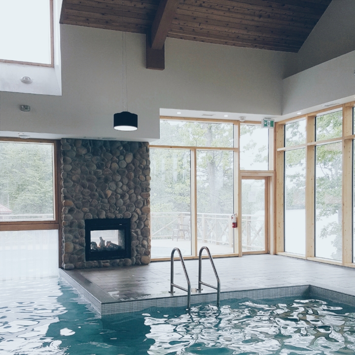 A sauna and eucalyptus steam room are tucked just out of frame of the indoor/outdoor pool.
