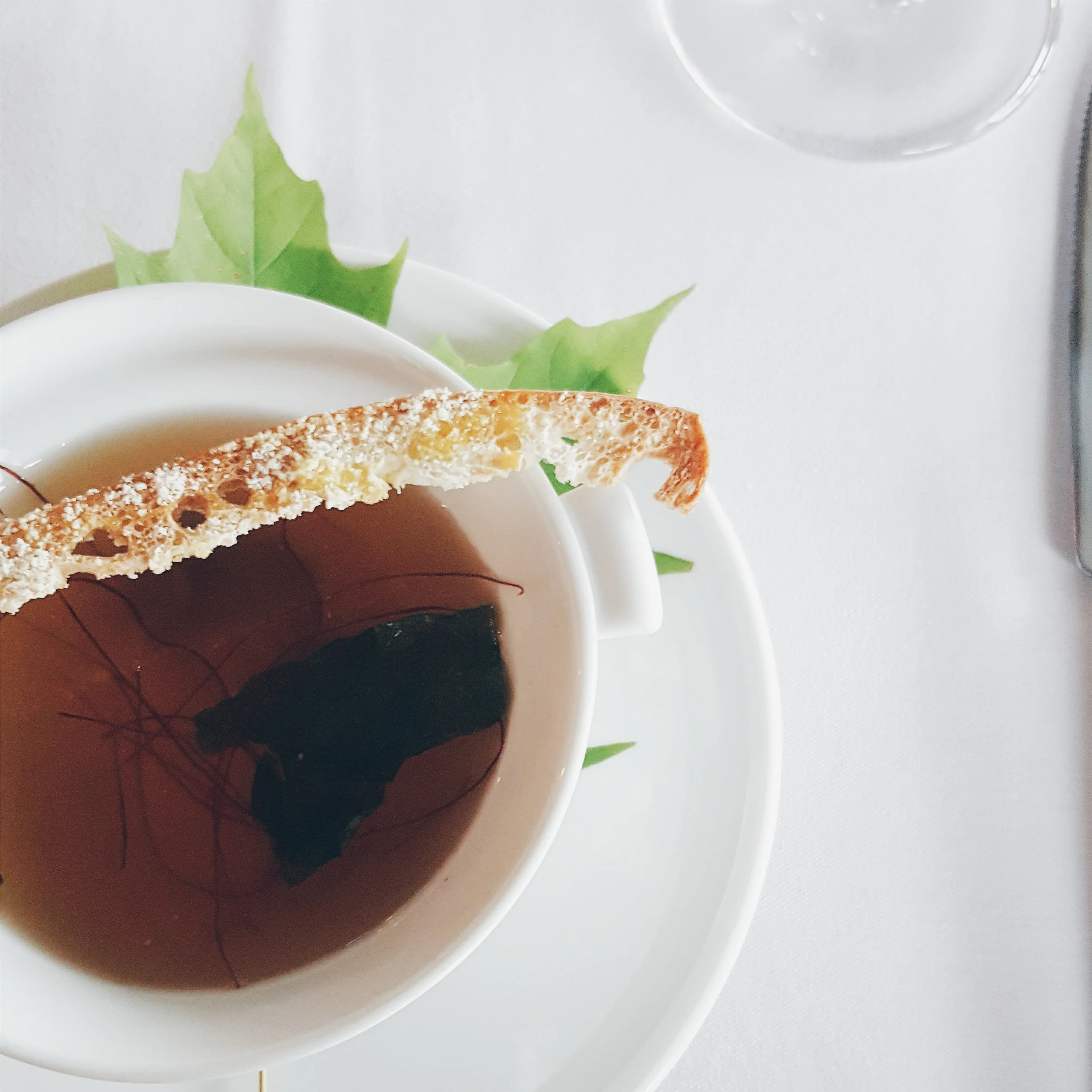 Heirloom Tomato Gazpacho with Sherry Jelly, Crisp Ciabatta, Oregano Flowers & Basil.