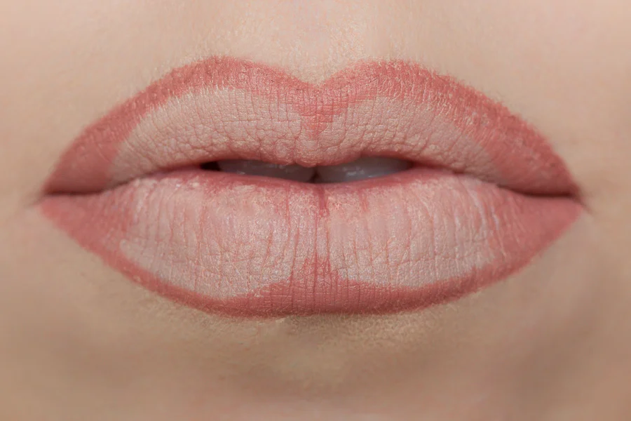 With the same lipliner, you are going to fill in the outer corners and the center of the lip. This will create depth in your lips which in return add dimension hence making your lips look fuller.
