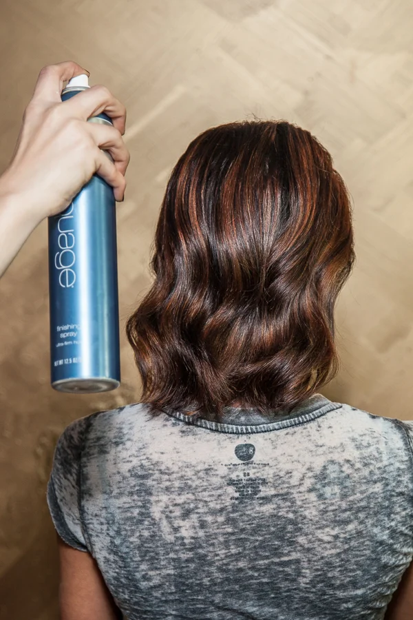 After you have brushed through the hair, take a firm but flexible hairspray and spray root to ends, 8-10 inches away to calm down any fly-aways, give shine and strength to the hair. I used Aquage Finishing Spray . 