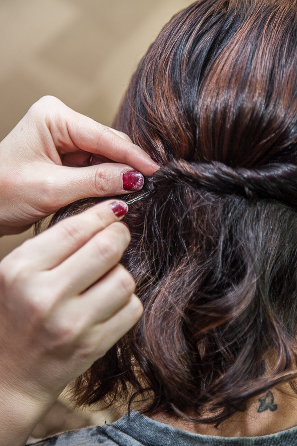 Take another bobby pin through another section of the twist and press it in and up at the opposite angle of the first one.