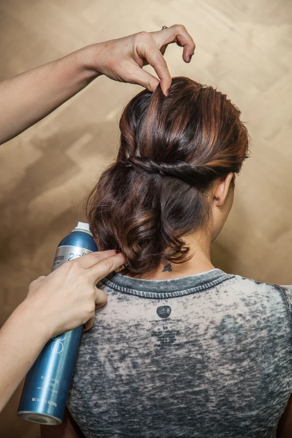 Very carefully, pull up on the top of the hair to create volume and movement. I constantly spray the Finishing Spray while I'm working to make sure the hair is not too soft and keeps the shine.