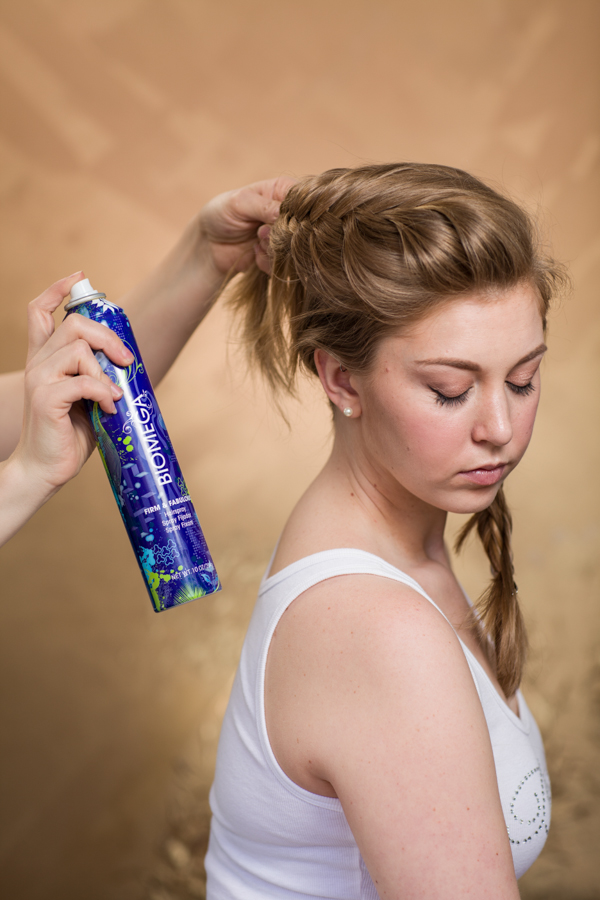 Let the top section down that was pinned out of the way. Create a french braid fishtail braid. For volume, be sure to elevate the braid as you're going. Continue braiding until you meet up with the other two braids on the right side of the head. 