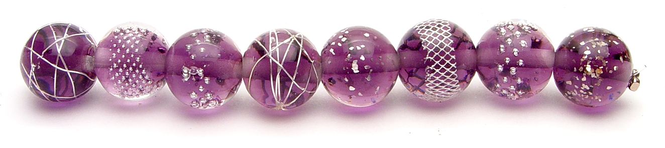 I love these beads! They're uber high tech with the silver inclusions... all the silver is held underneath a top layer of clear glass so they never tarnish or get knocked off. They're just so clean looking and fun. 