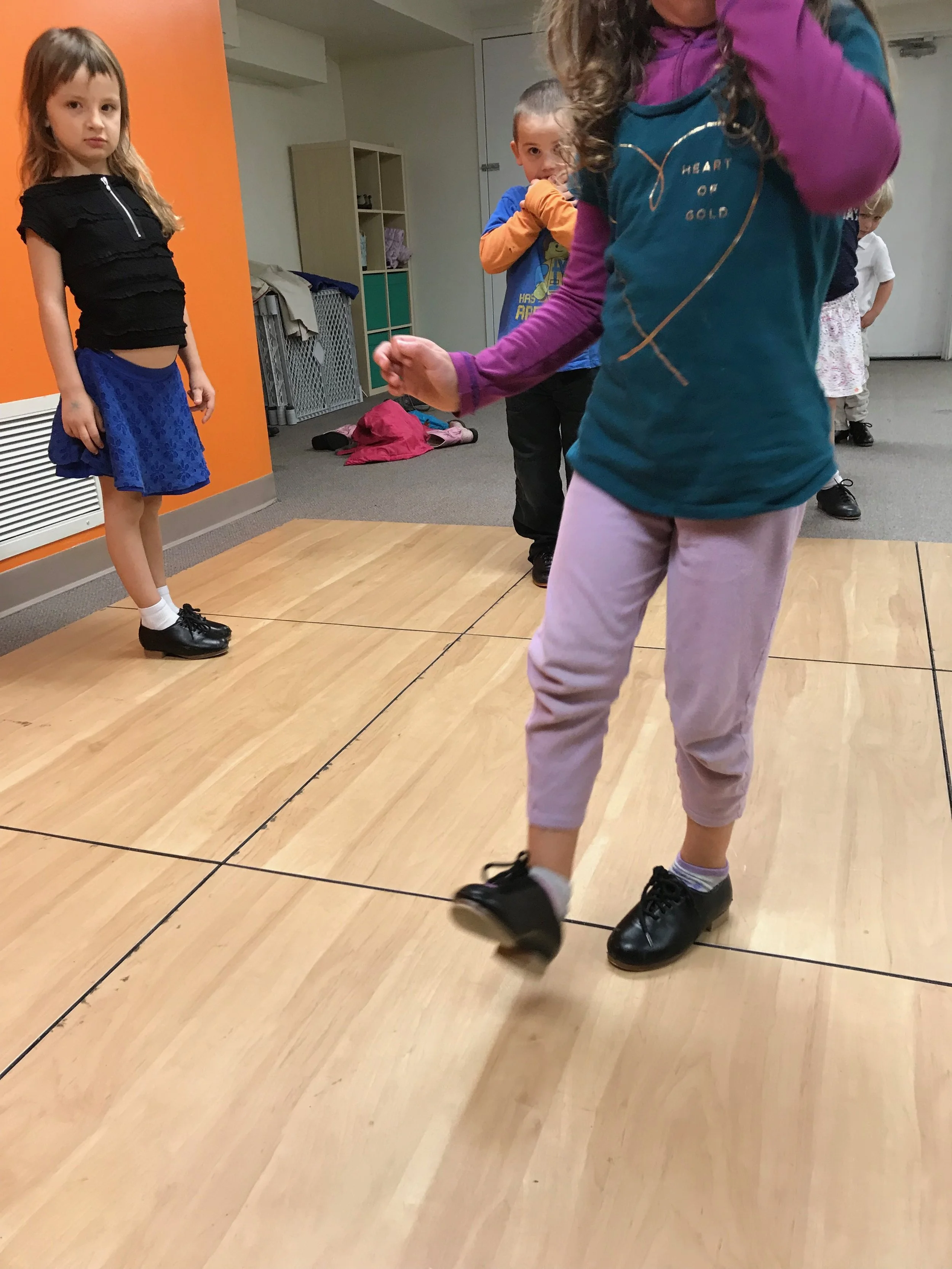 We also worked "across the floor" using our DEE DUMS to move us! Lining up, I gave the first person a pattern. Once they did my pattern, they got to give the next person a pattern to do! Here, Rose gave a pattern to Shannon to perform, and she is watching to make sure that Shannon is doing it correctly!