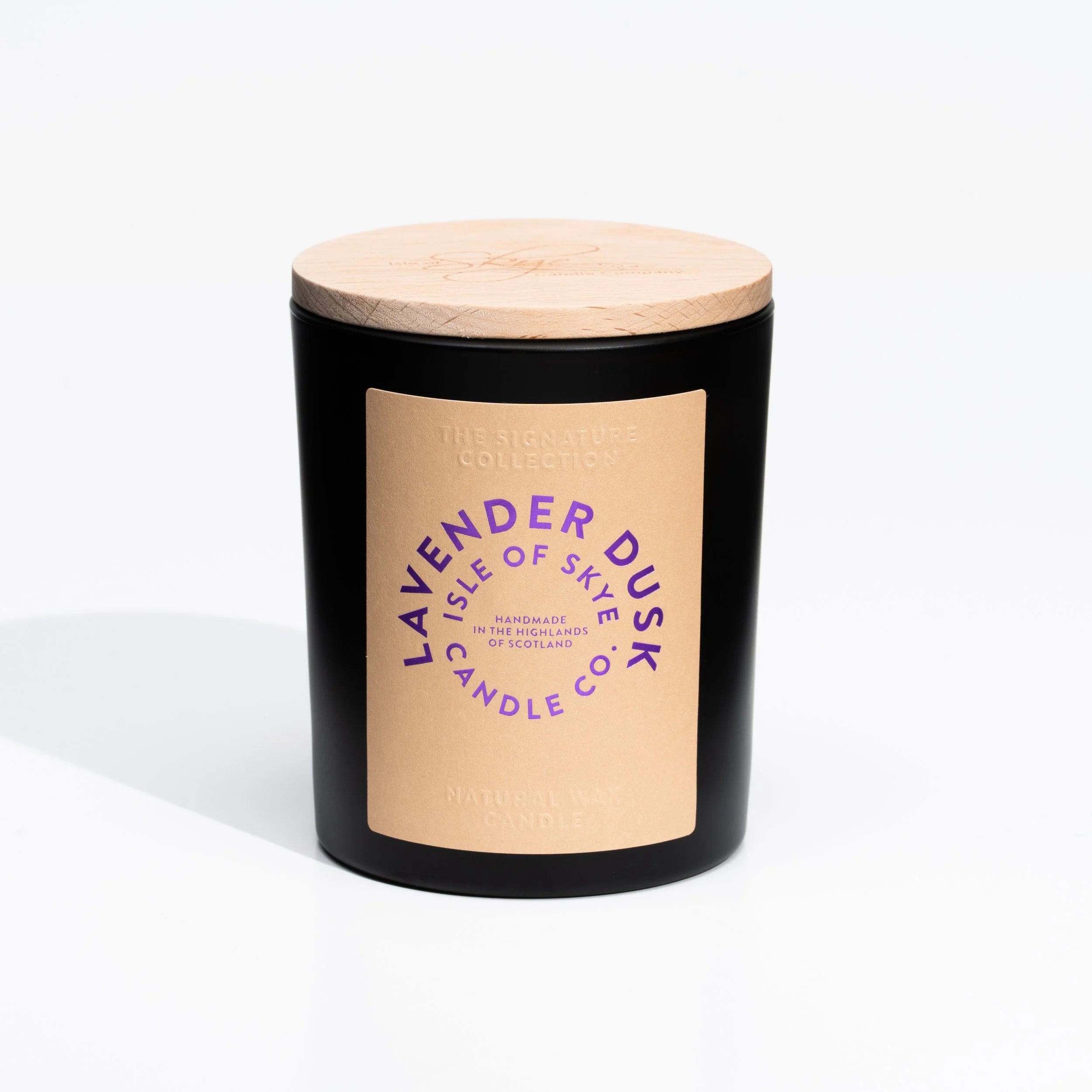 Black candle jar with a beige label and a wooden lid, labeled 'LAVENDER DU SK CANDLE CO.', handmade in Scotland, from The Signature Collection.