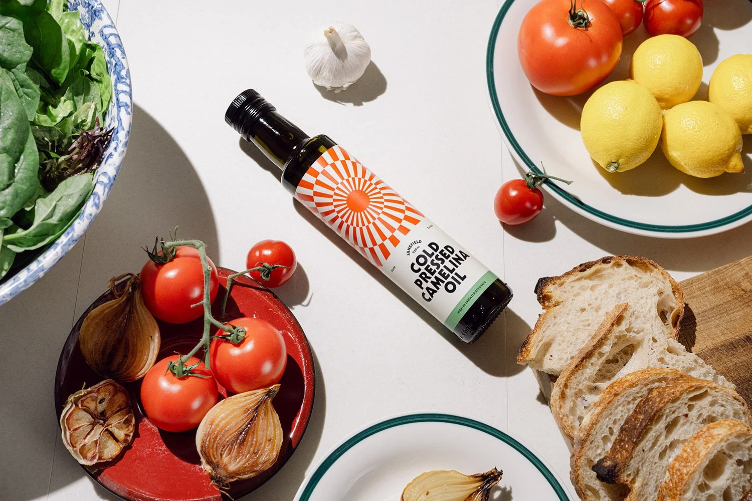 Styled styled food photography - a bottle of seed oil with healthy vegetables