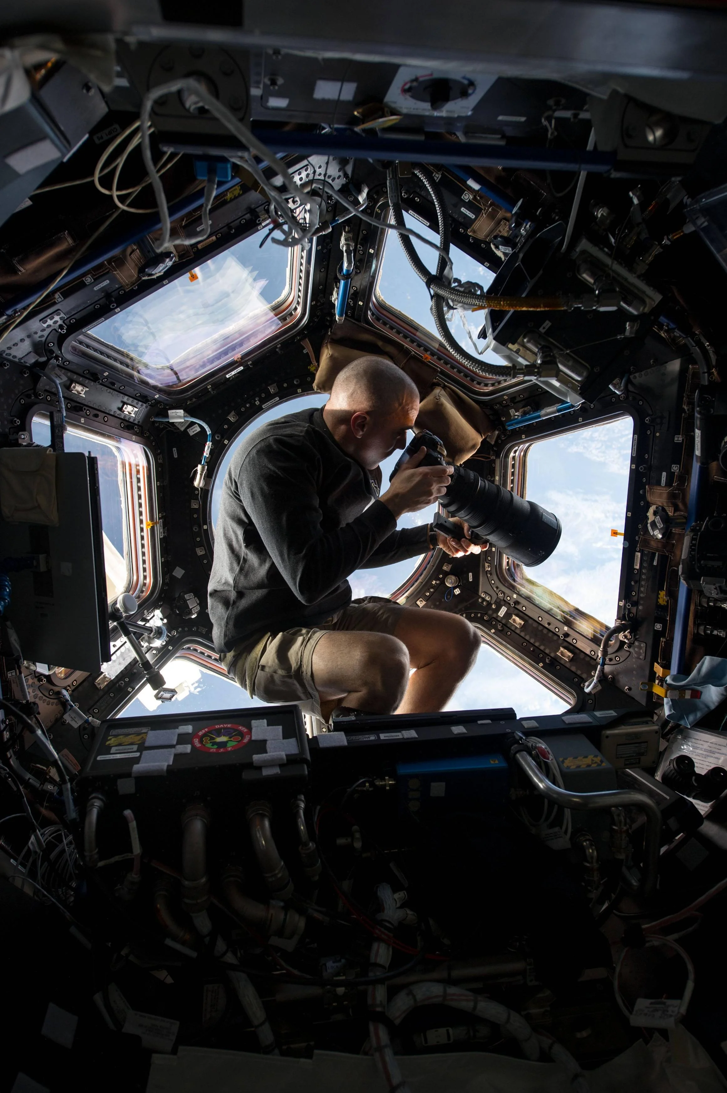 NASA astronaut Chris Cassidy taking a photo from the ISS's cupola viewport. Image by NASA.
