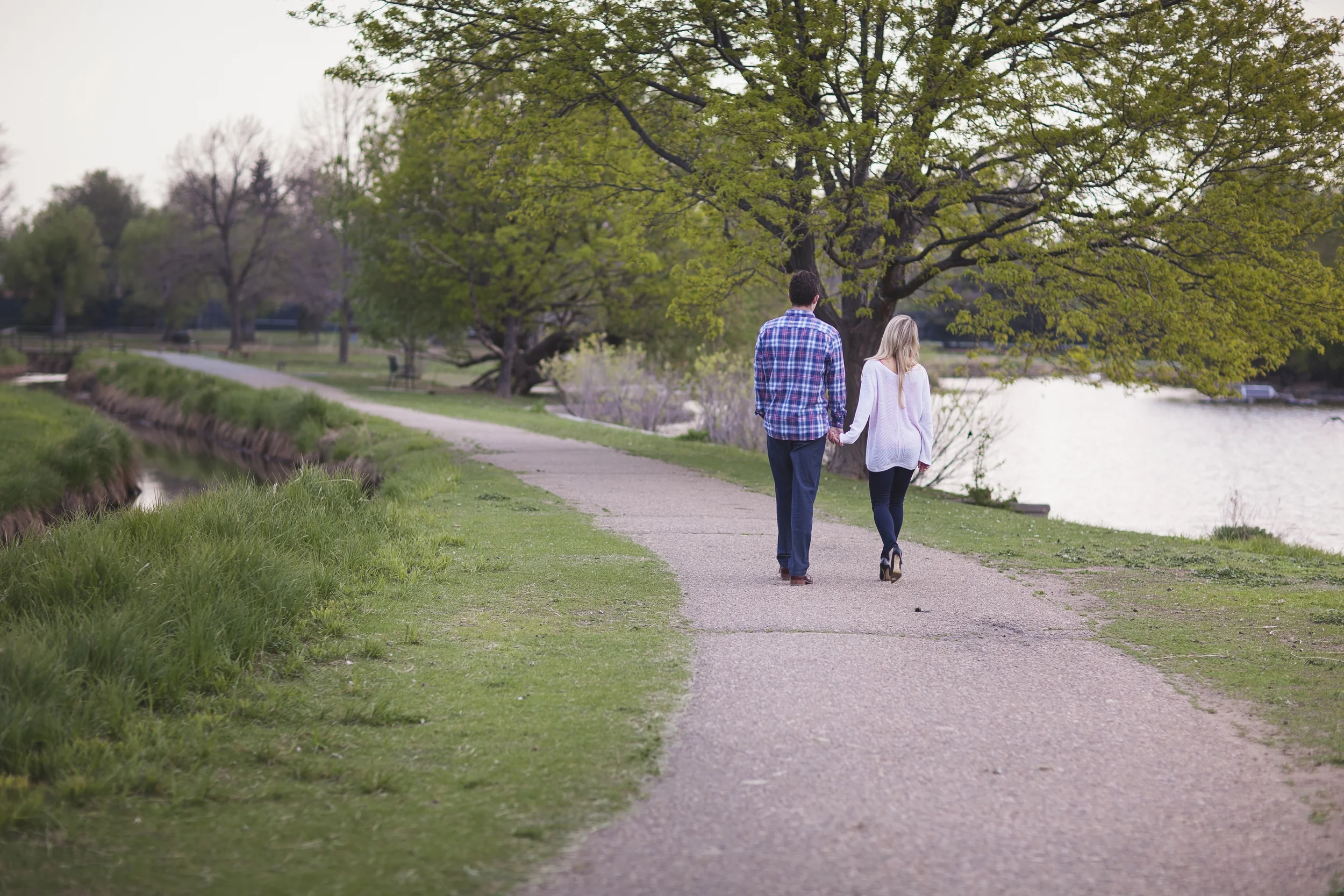 Denver Colorado engagement photography session with couple walking away on path hand in hand