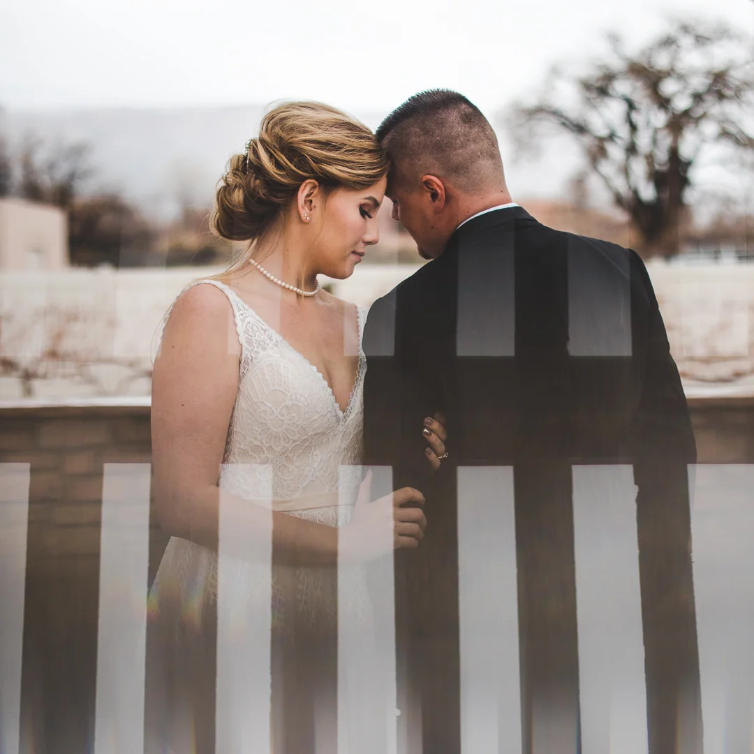 Prism reflected shot of bride and groom embracing