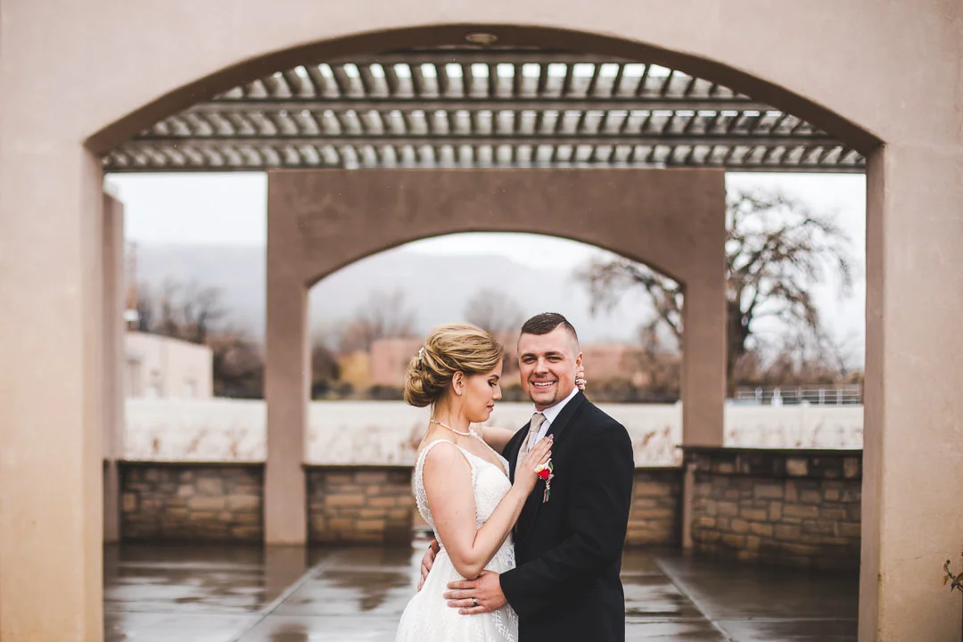 Bride looking at groom who looks at cameraman