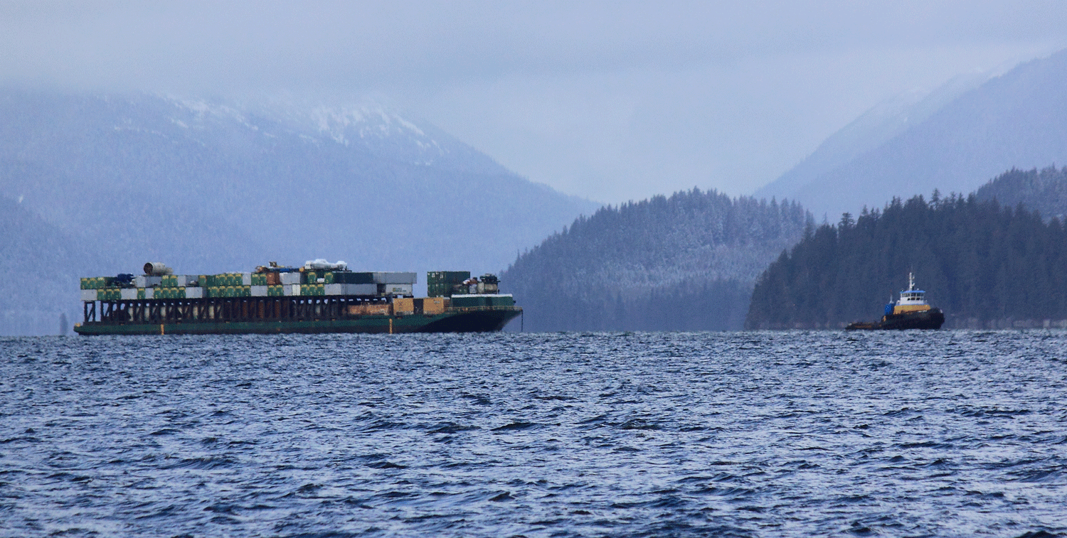 Oceangoing tug and barge in the protection of the islands, waiting for the weather on the outside to settle down.