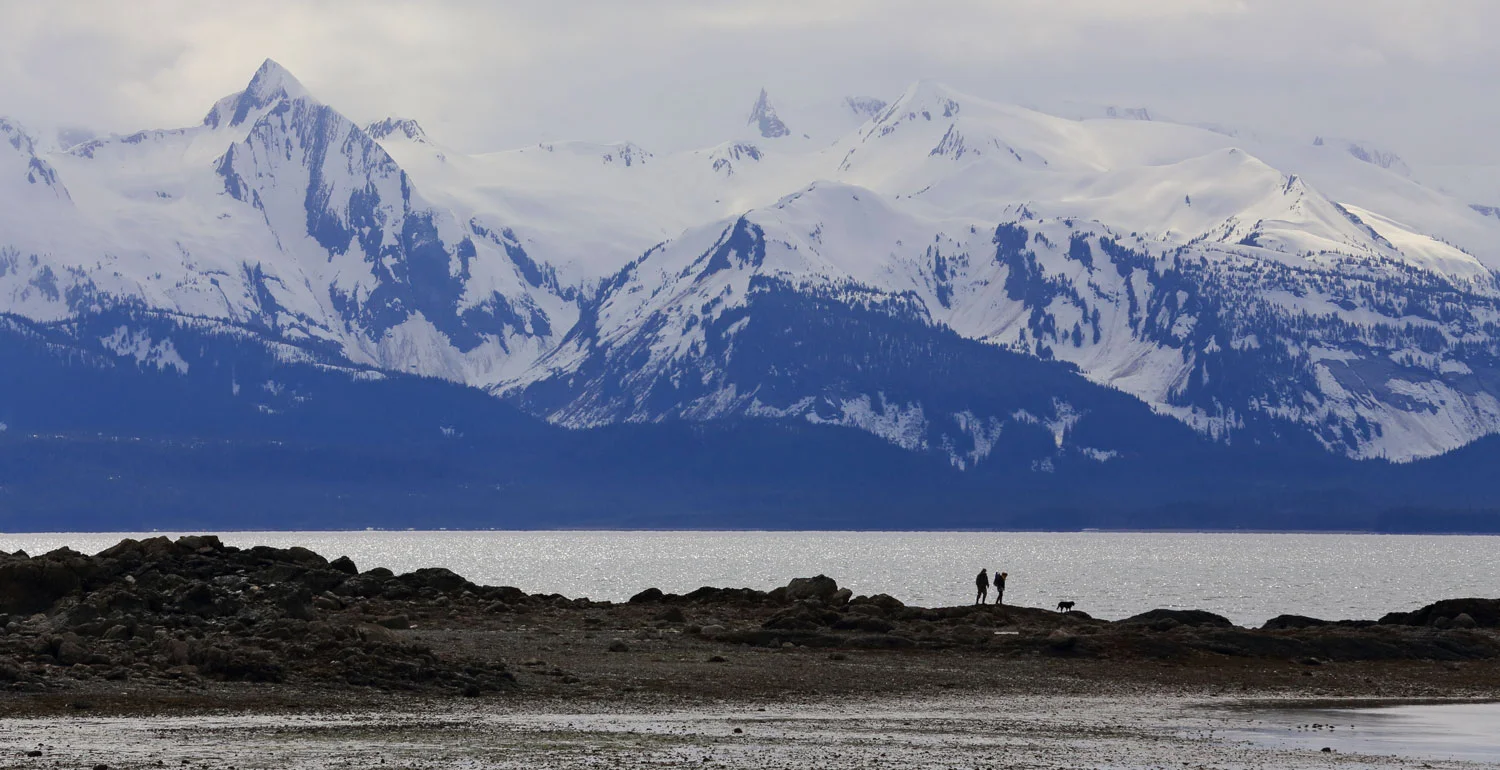 A family explores the point at Bridgett Cove.