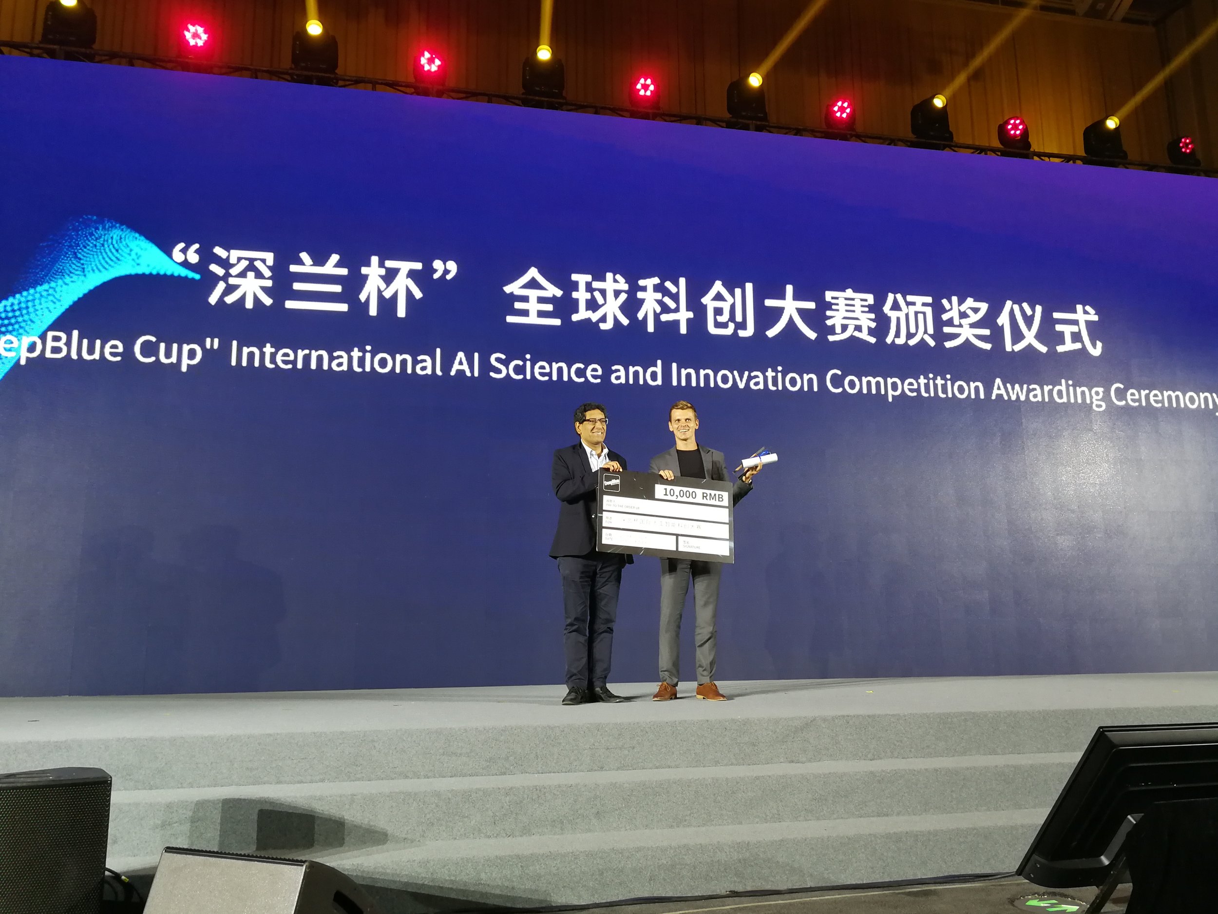 Matt Morawski holding the 10,000 RMB check and the winning certificate.