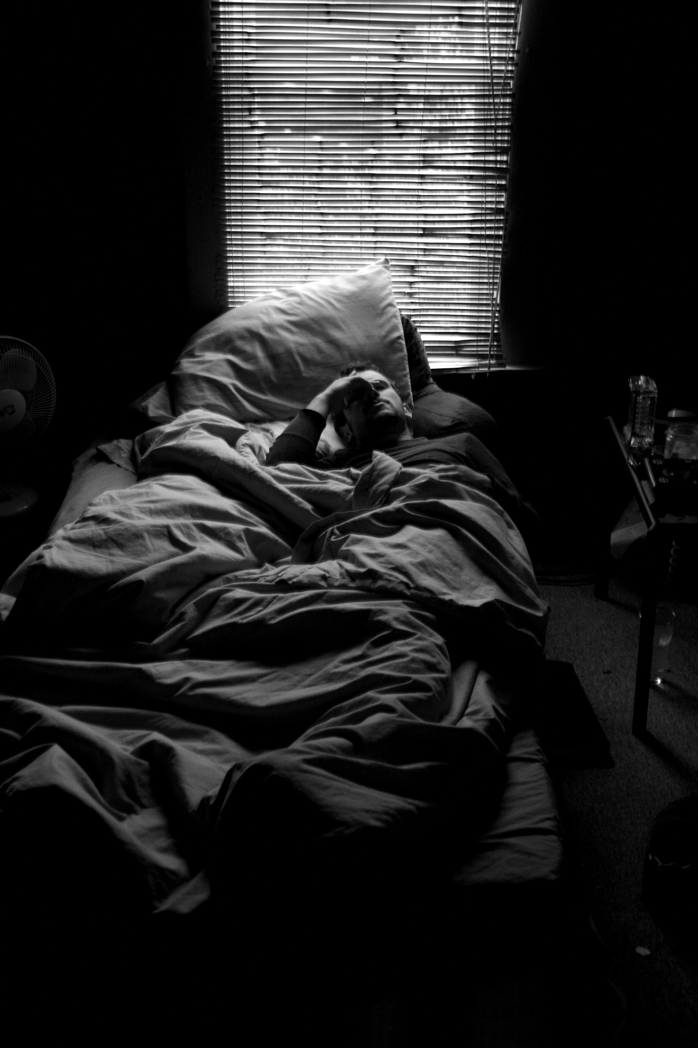 Ray Monge wakes from a nap in his apartment in Athens Ohio. 