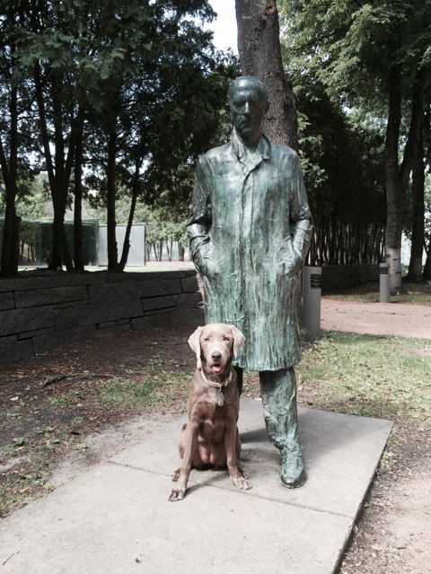   A man and his dog. The quote by the sculpture, "The archaic Greek walking man's spine is very erect and he has one foot forward and his arms are straight down, and he's as much Greek as he is Egyptian as he is Greek. It goes on and on through Giaco